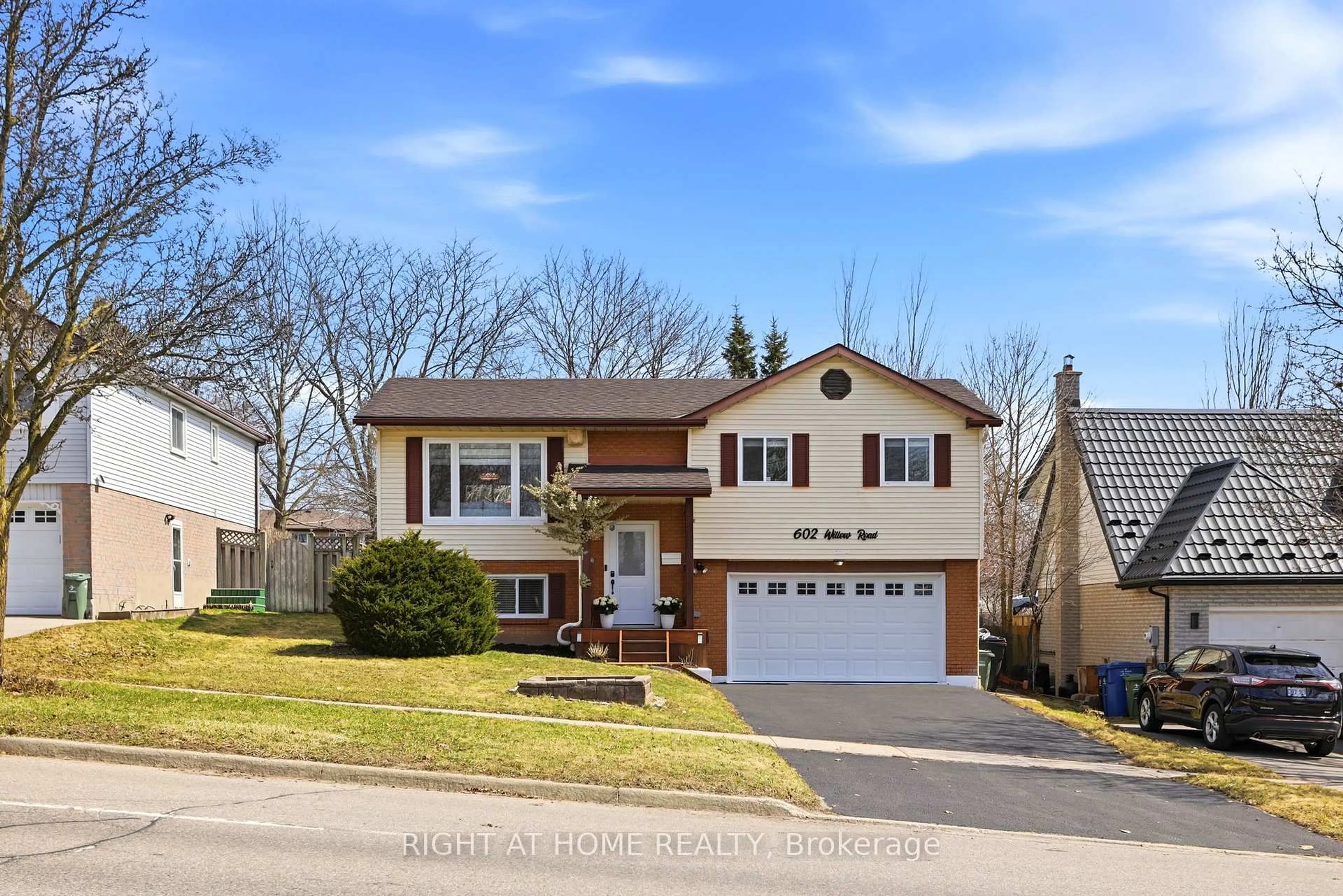 Home with vinyl exterior material, street for 602 WILLOW Rd, Guelph Ontario N1H 7M5