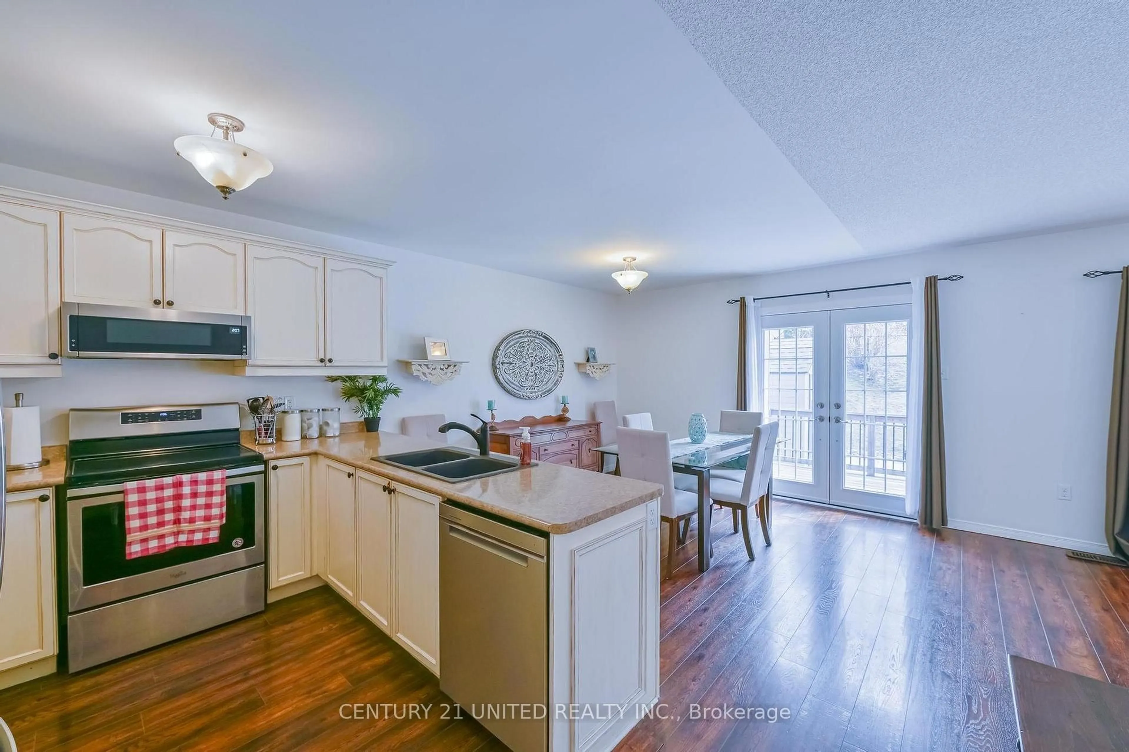 Open concept kitchen, wood/laminate floor for 833 Bertrand Terr, Peterborough Ontario K9K 2T1