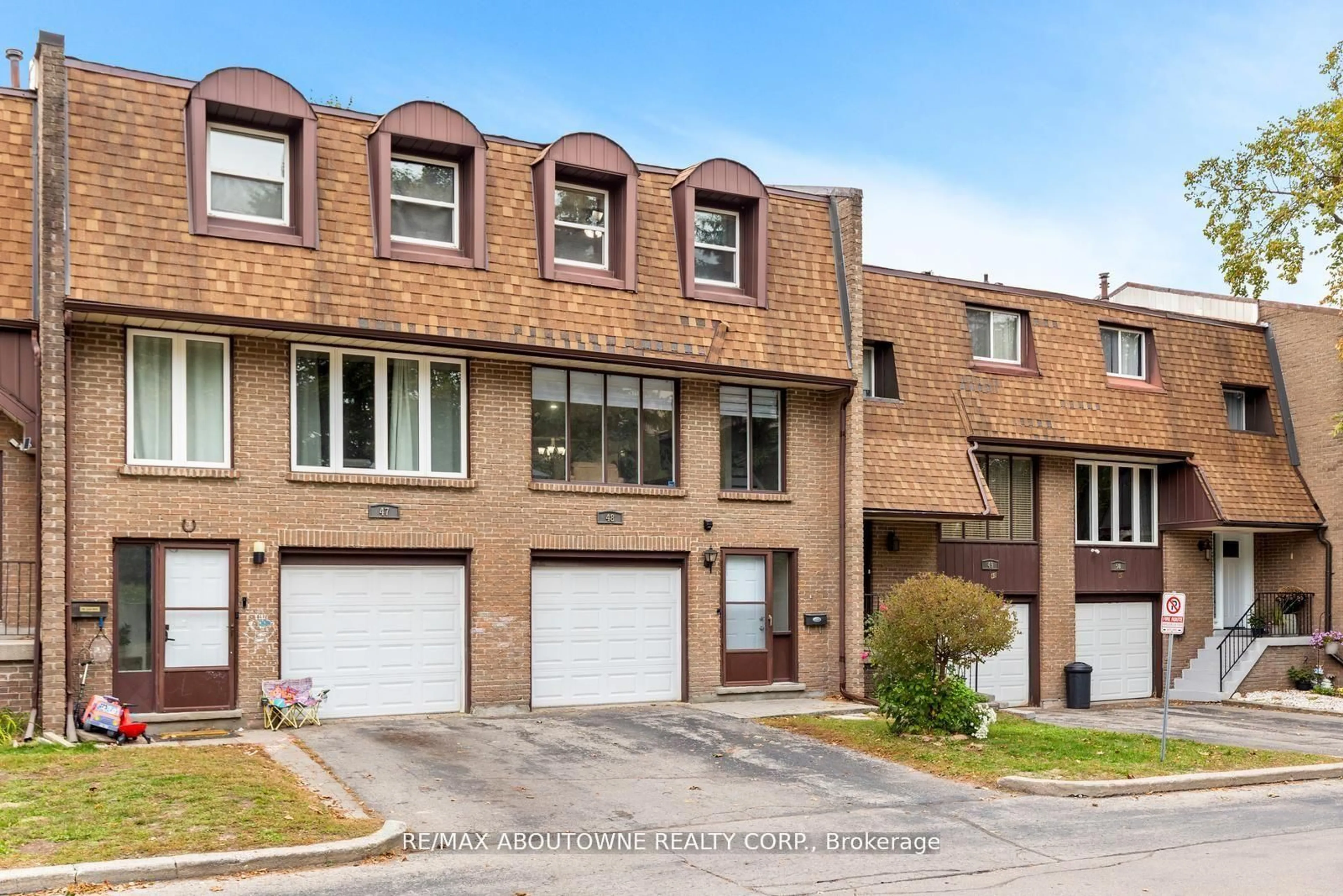 Home with brick exterior material, street for 49 Cedarwoods Cres #48, Kitchener Ontario N2C 2L1