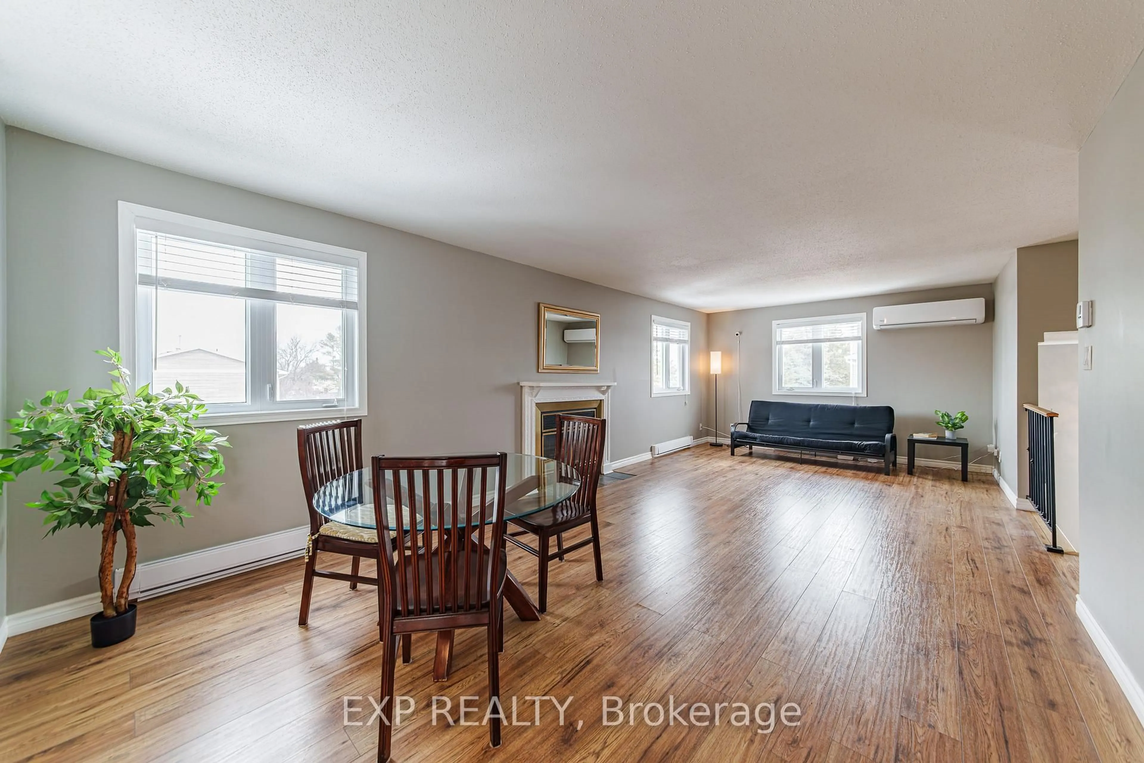 Living room with furniture, wood/laminate floor for 10 Castlegreen Private, Ottawa Ontario K1T 3N2