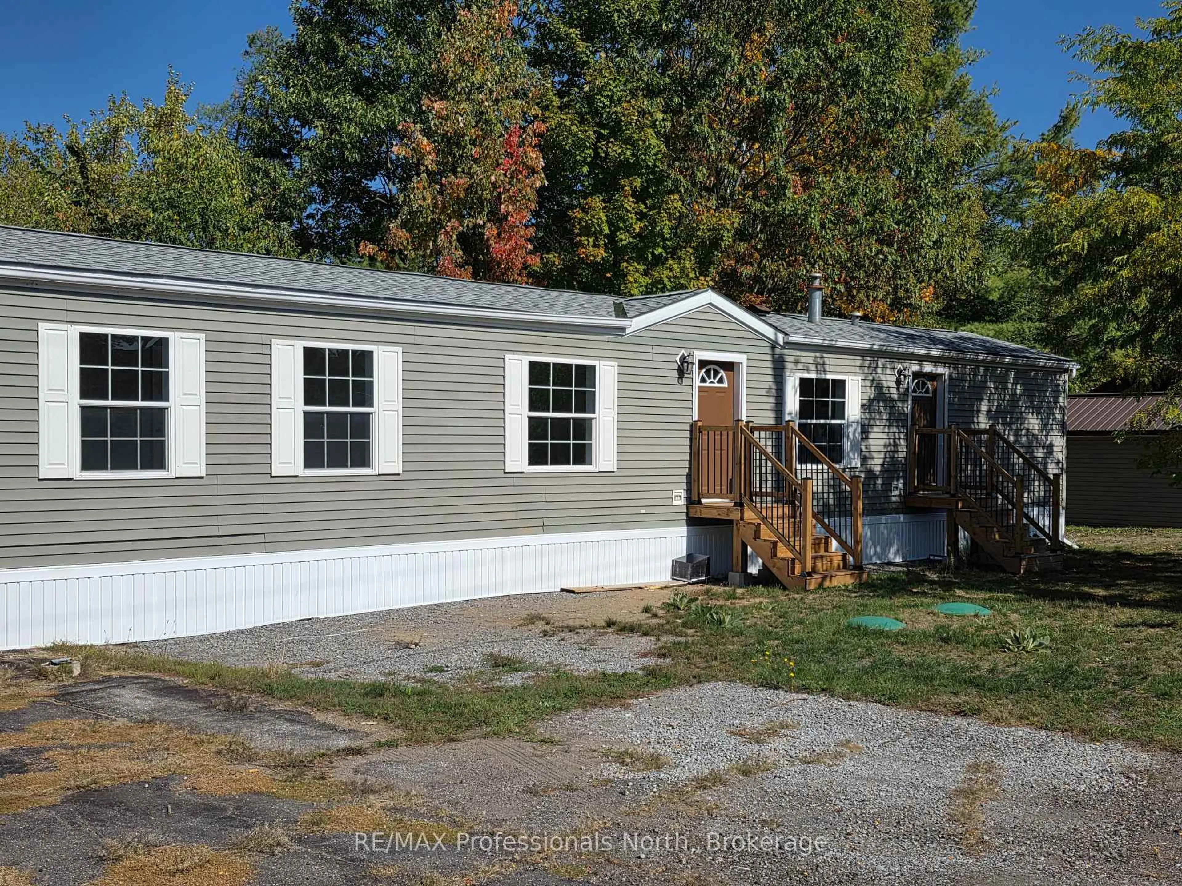 Home with vinyl exterior material, street for 1013 Seventh Lane, Minden Hills Ontario K0M 2K0