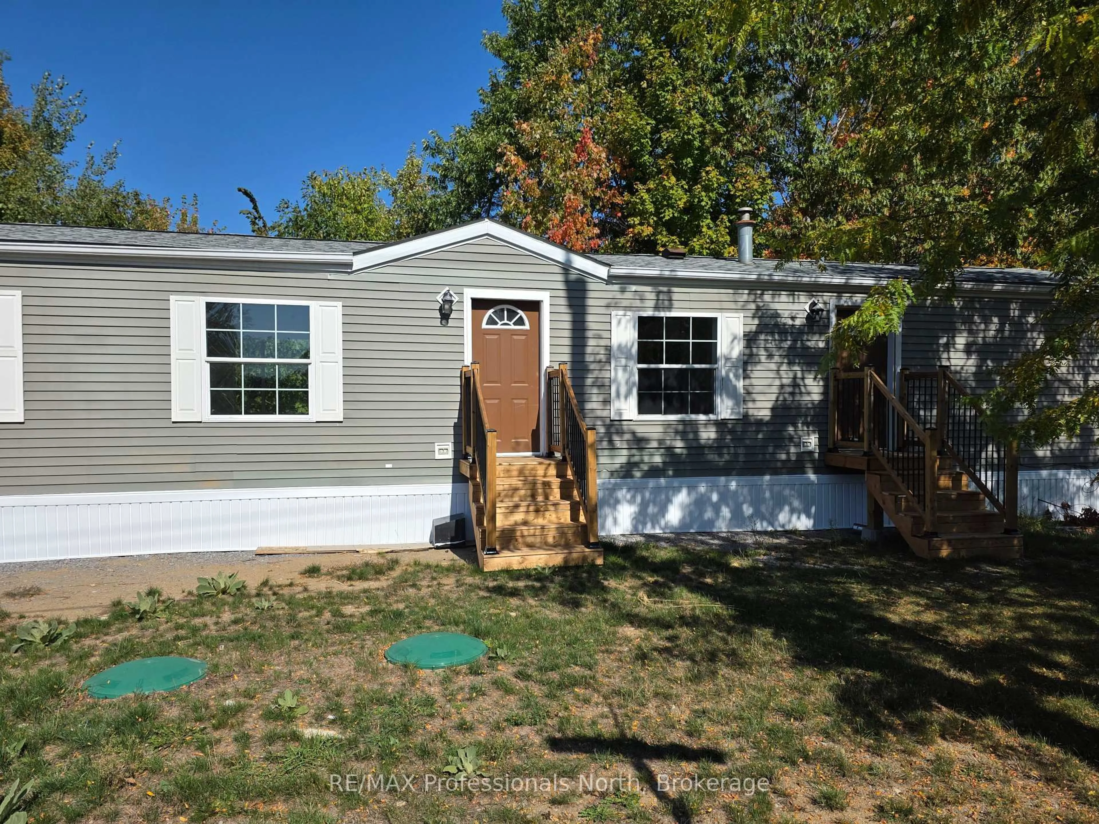 Home with vinyl exterior material, street for 1013 Seventh Lane, Minden Hills Ontario K0M 2K0
