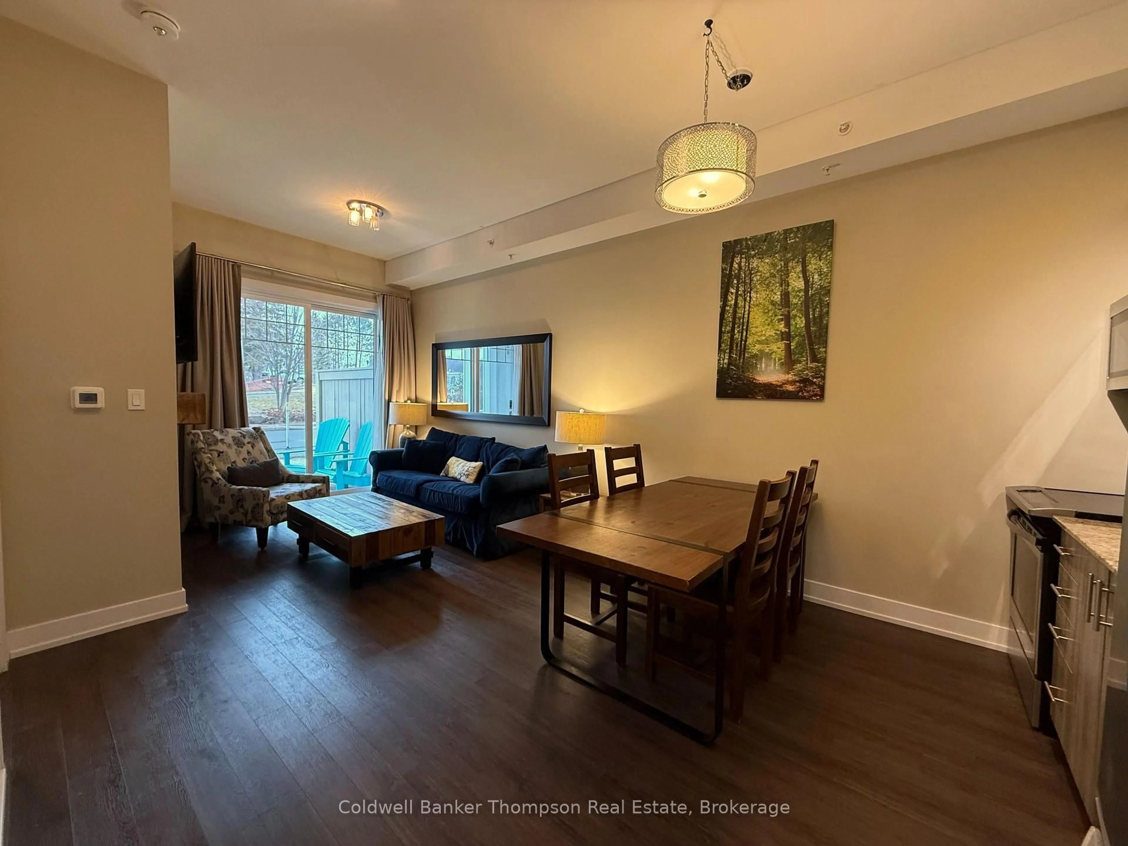 Living room with furniture, wood/laminate floor for 25 PEN LAKE POINT Rd #110, Huntsville Ontario P1H 1A9