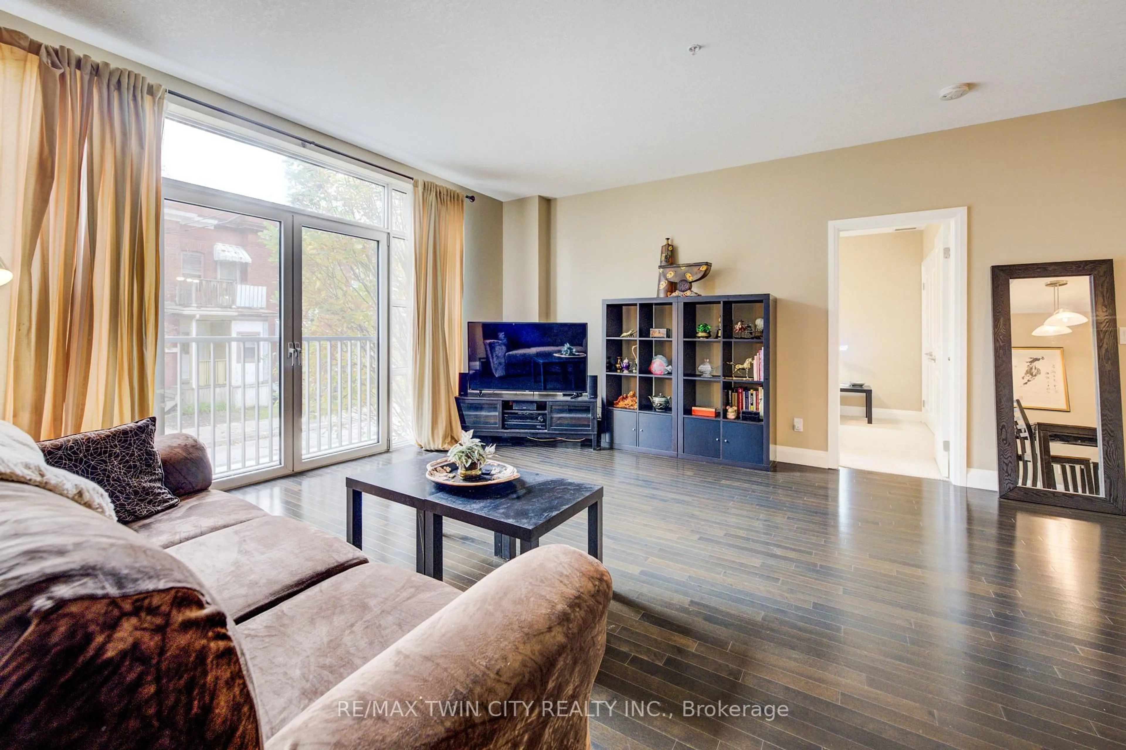 Living room with furniture, wood/laminate floor for 165 Duke St #105, Kitchener Ontario N2H 6T8