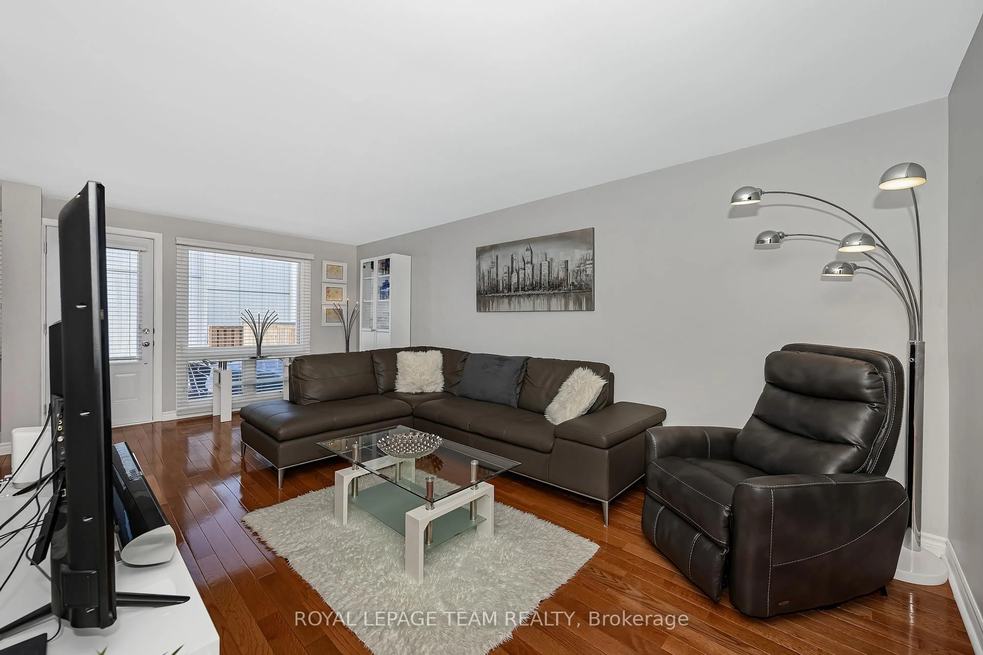 Living room with furniture, wood/laminate floor for 18 Benlea Dr #C, Ottawa Ontario K2G 4A8