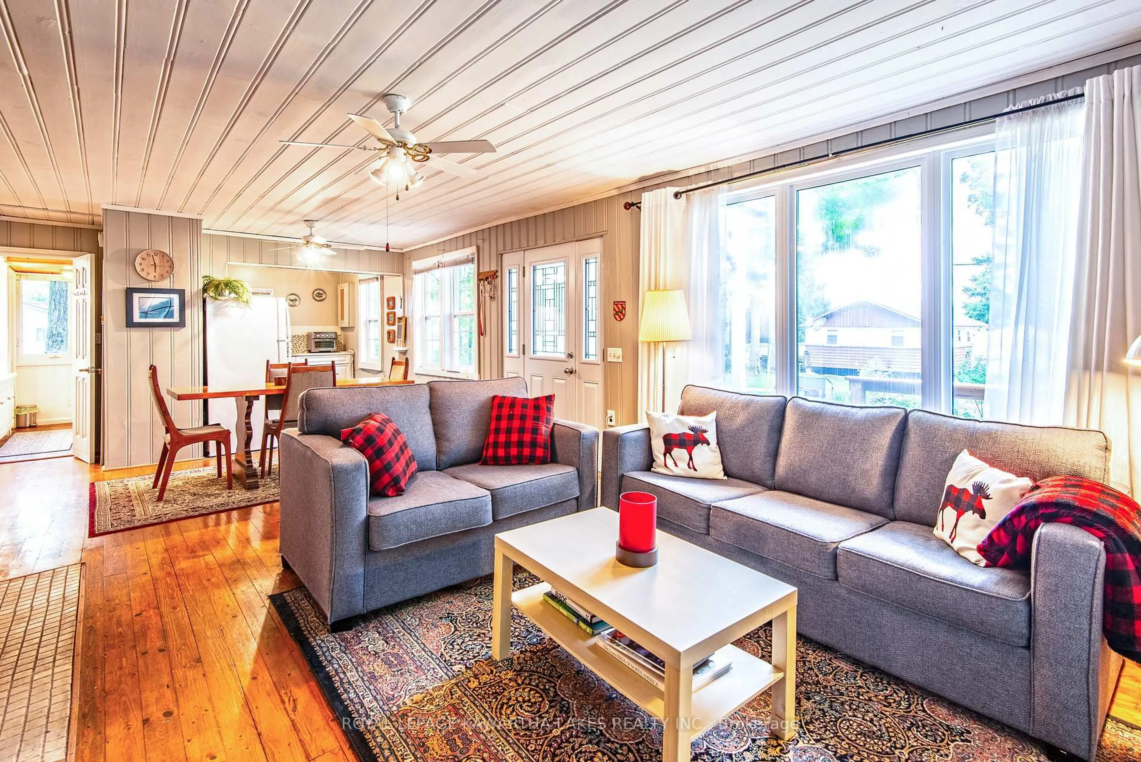 Living room with furniture, wood/laminate floor for 130 Driftwood Village Dr, Kawartha Lakes Ontario K0M 1K0