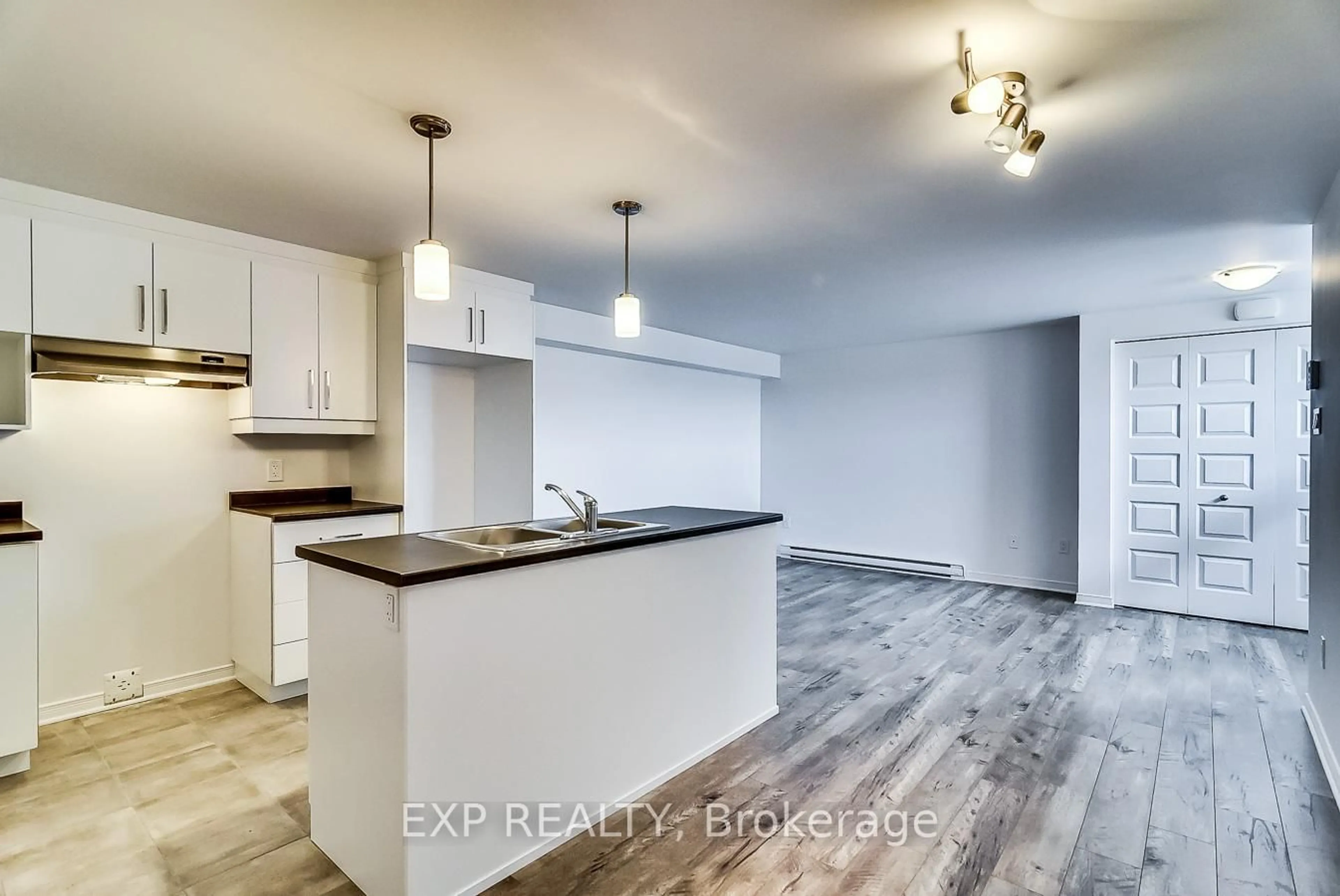 Open concept kitchen, wood/laminate floor for 259 Carpe St, Casselman Ontario K0A 1M0
