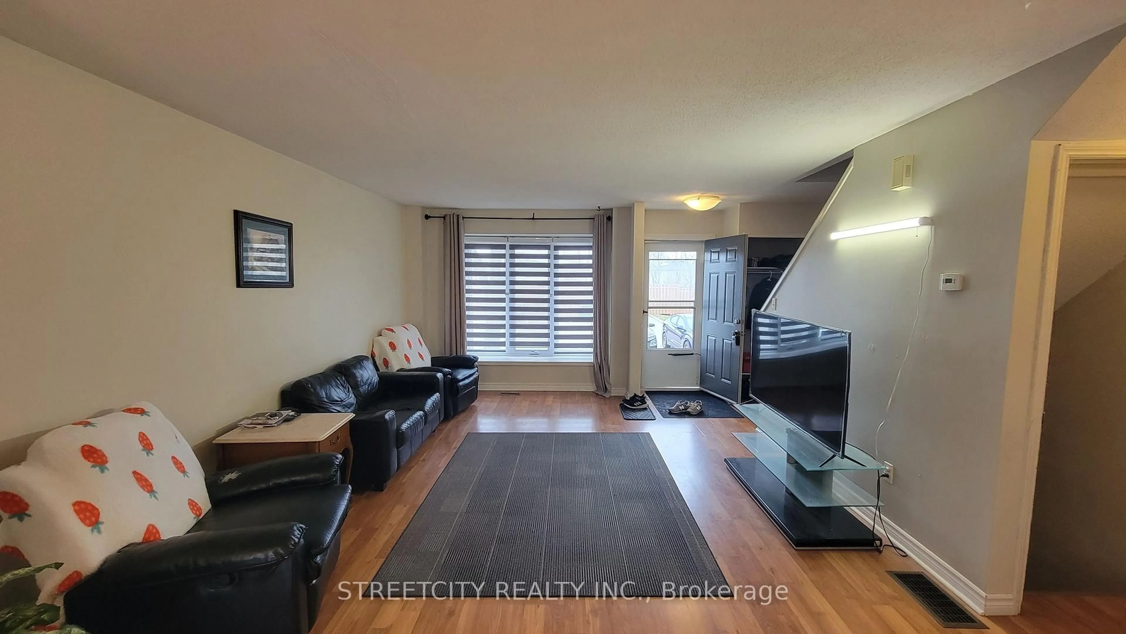 Living room with furniture, wood/laminate floor for 1138 Kipps Lane #17, London East Ontario N5Y 5K6