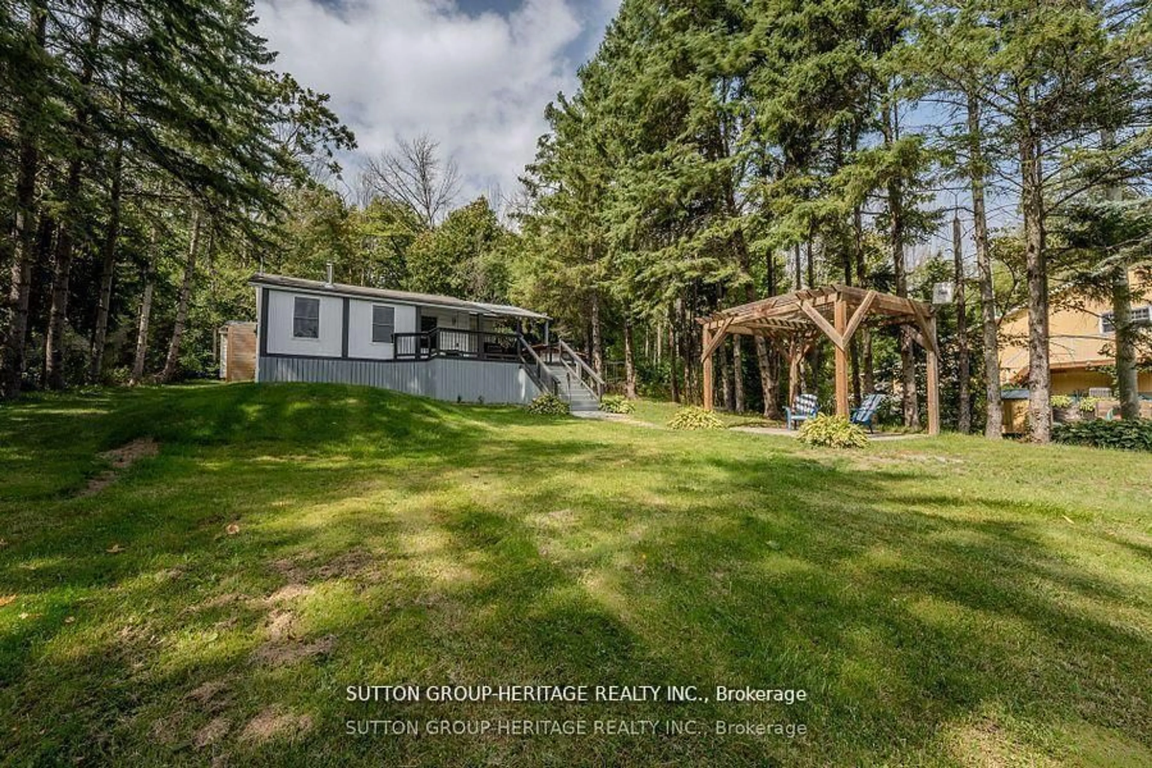 A pic from outside/outdoor area/front of a property/back of a property/a pic from drone, forest/trees view for 682 North Shore Dr, Otonabee-South Monaghan Ontario K0L 1B0