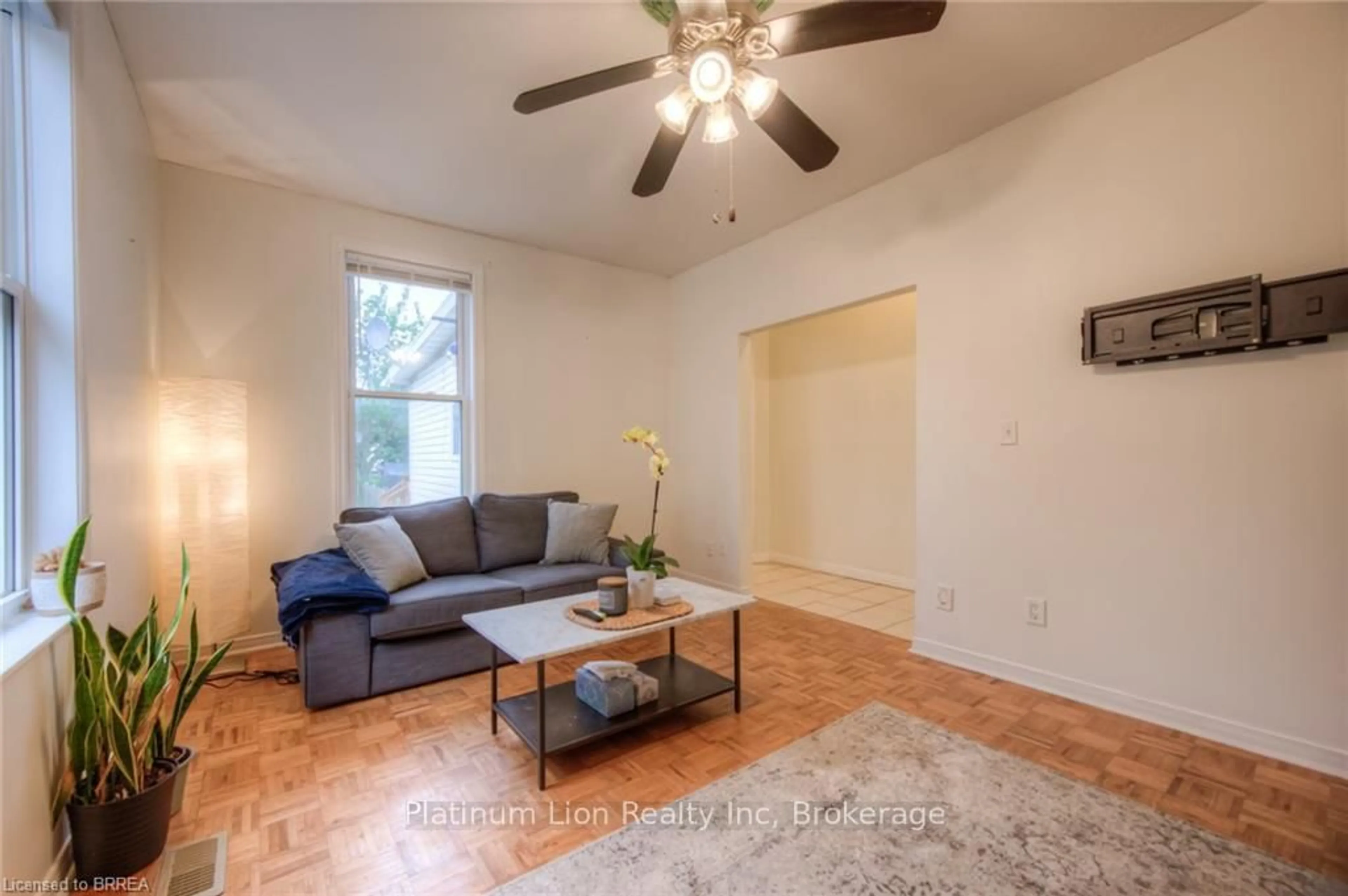 Living room with furniture, wood/laminate floor for 10 Bruce St, Brantford Ontario N3R 1E2