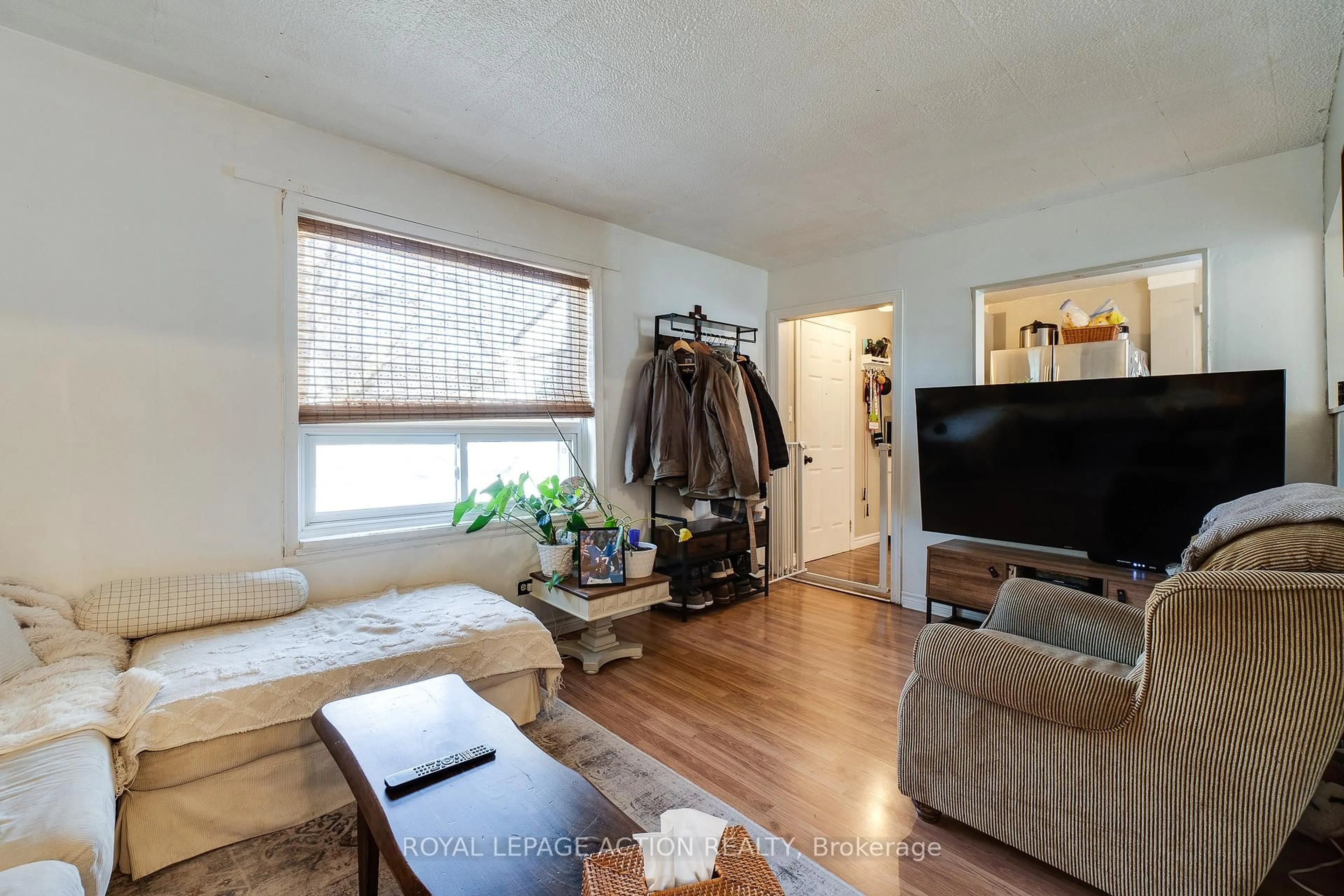 Living room with furniture, wood/laminate floor for 17 Drummond St, Brantford Ontario N3S 5Z2