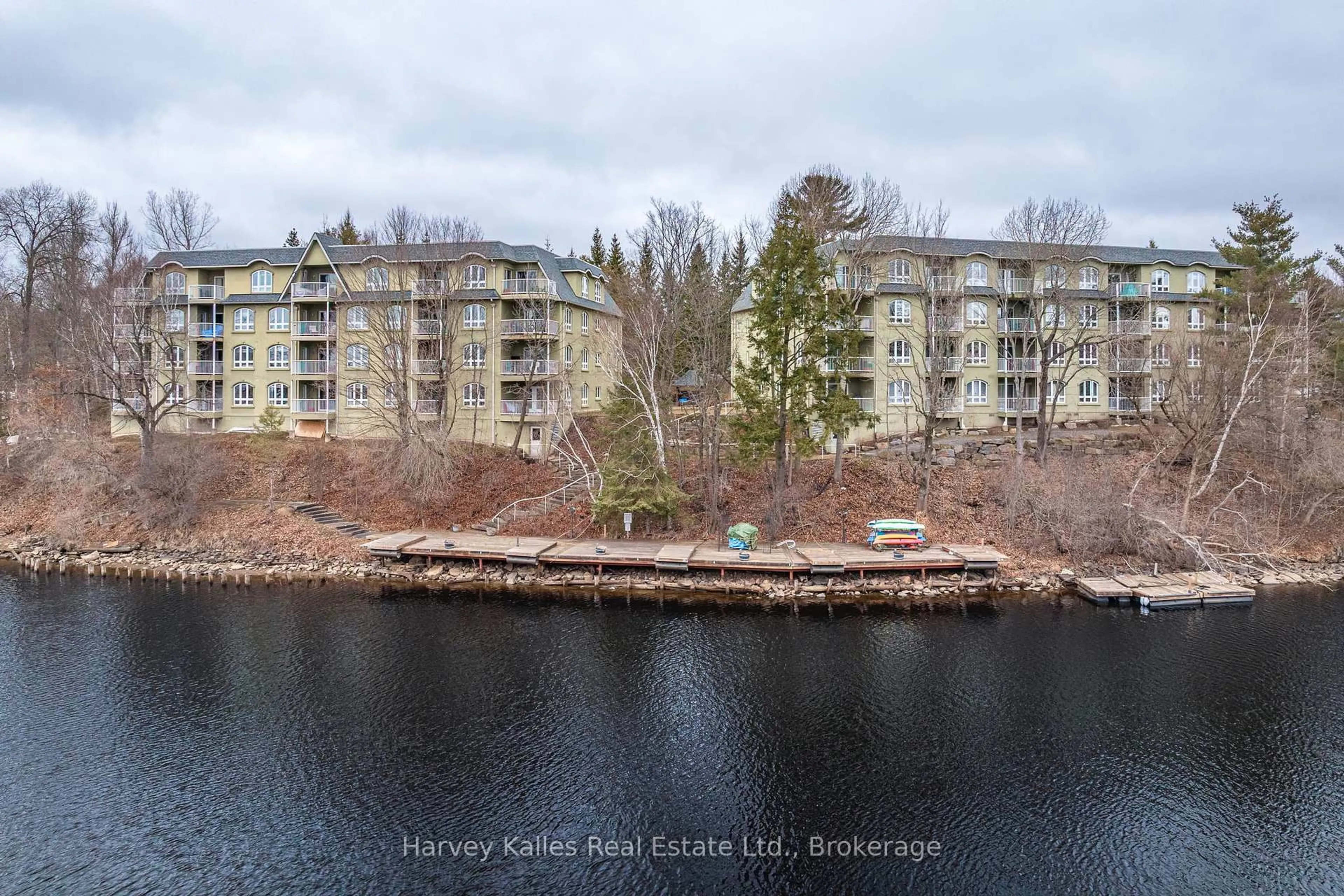 A pic from outside/outdoor area/front of a property/back of a property/a pic from drone, water/lake/river/ocean view for 31 Dairy Lane #107, Huntsville Ontario P1H 2L7