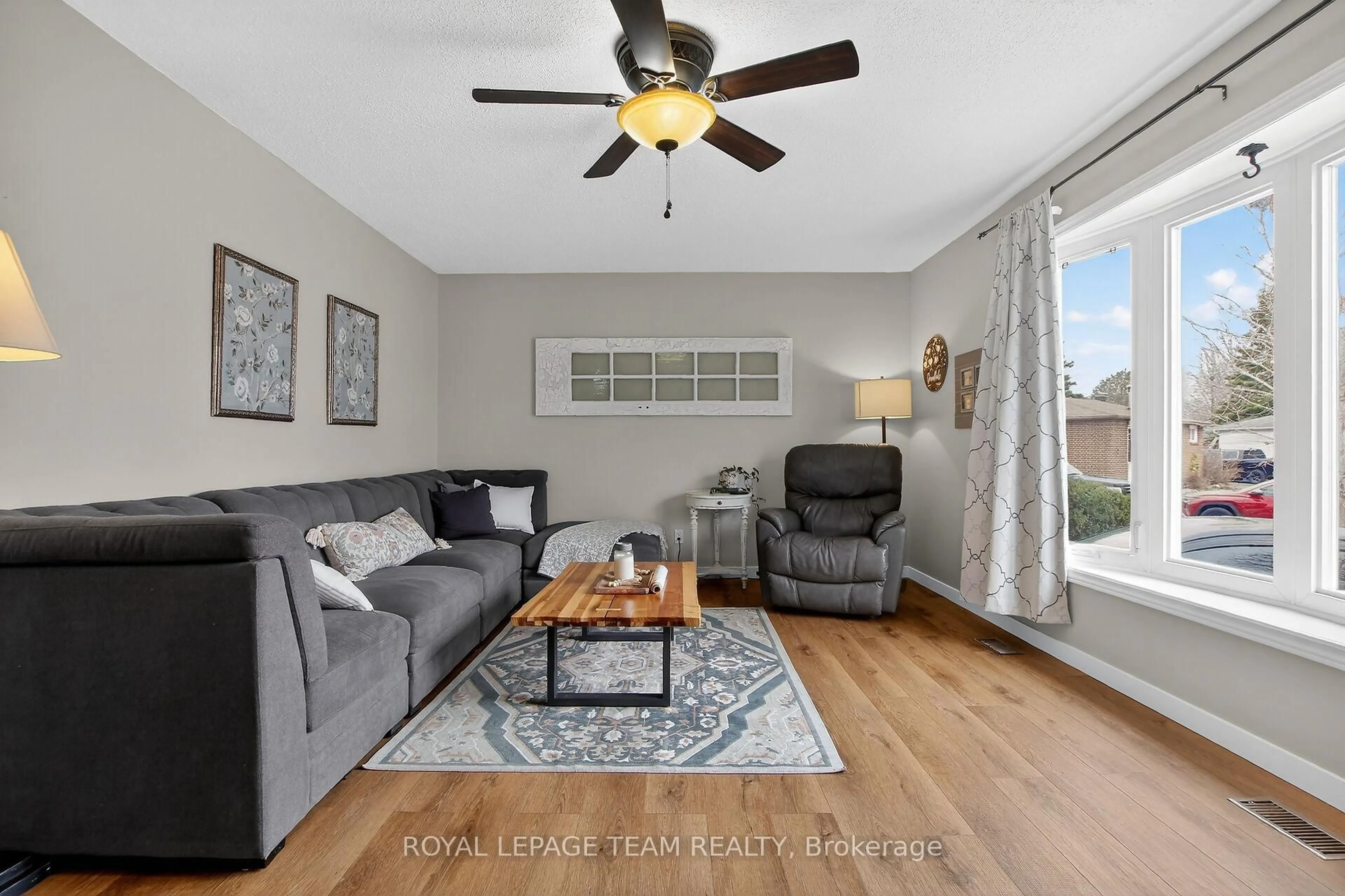 Living room with furniture, wood/laminate floor for 44 Ballantrae Way, Kanata Ontario K2L 1N5