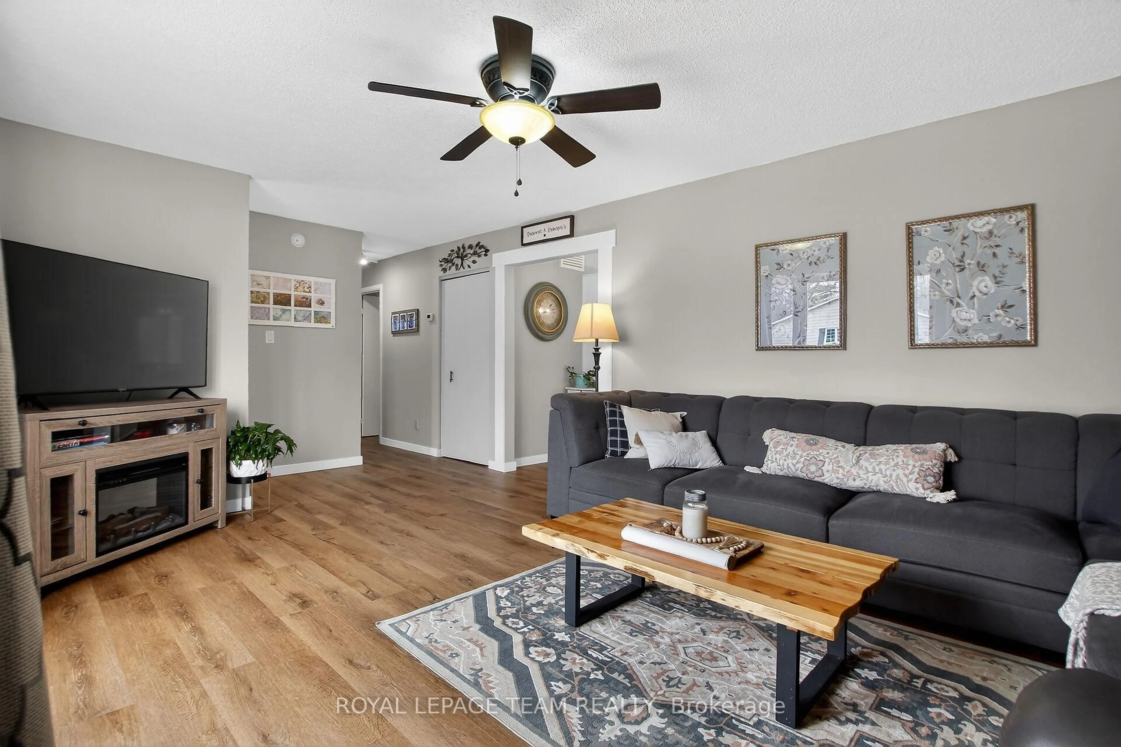Living room with furniture, wood/laminate floor for 44 Ballantrae Way, Kanata Ontario K2L 1N5