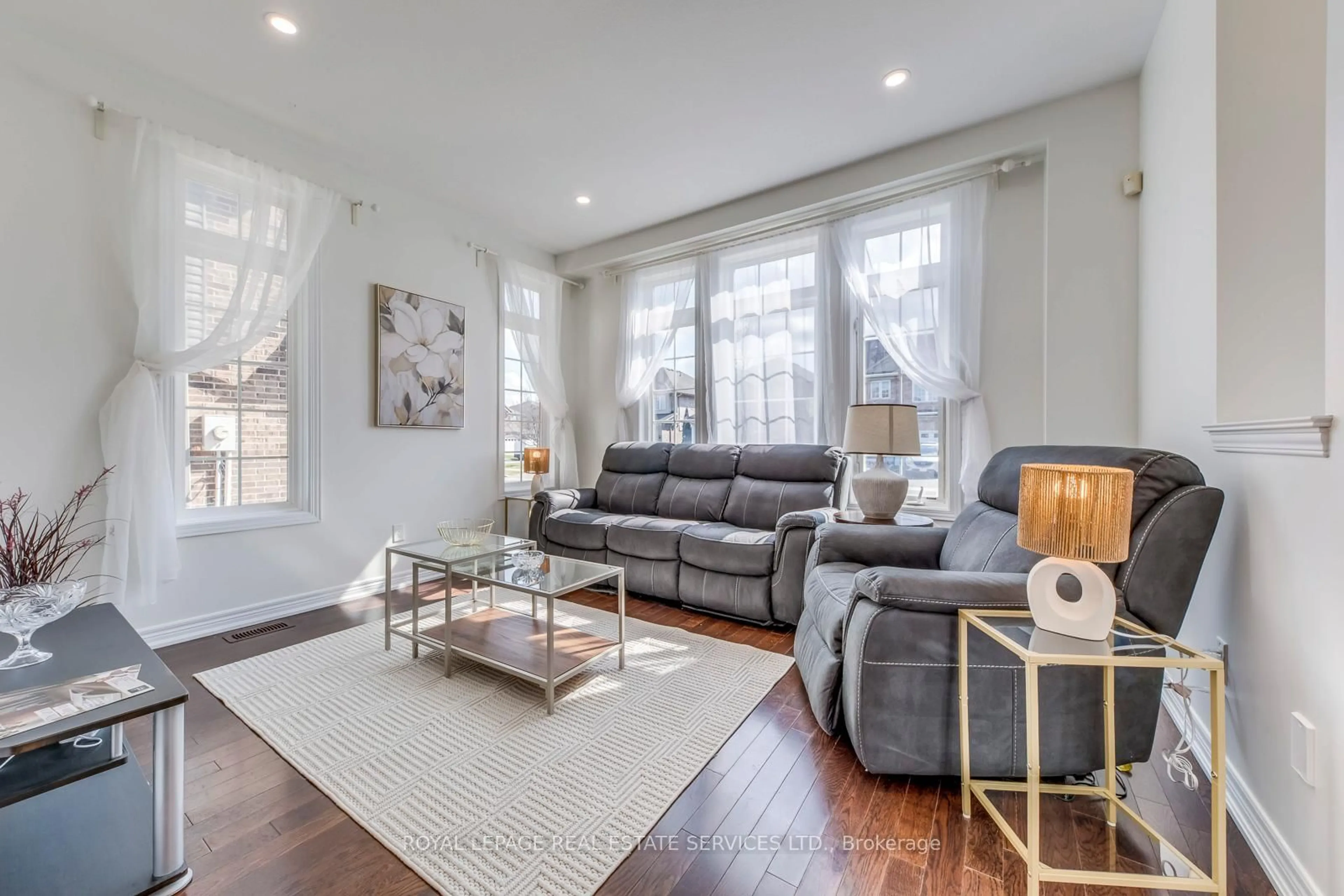 Living room with furniture, wood/laminate floor for 206 Brigadoon Dr, Hamilton Ontario L9C 0B5