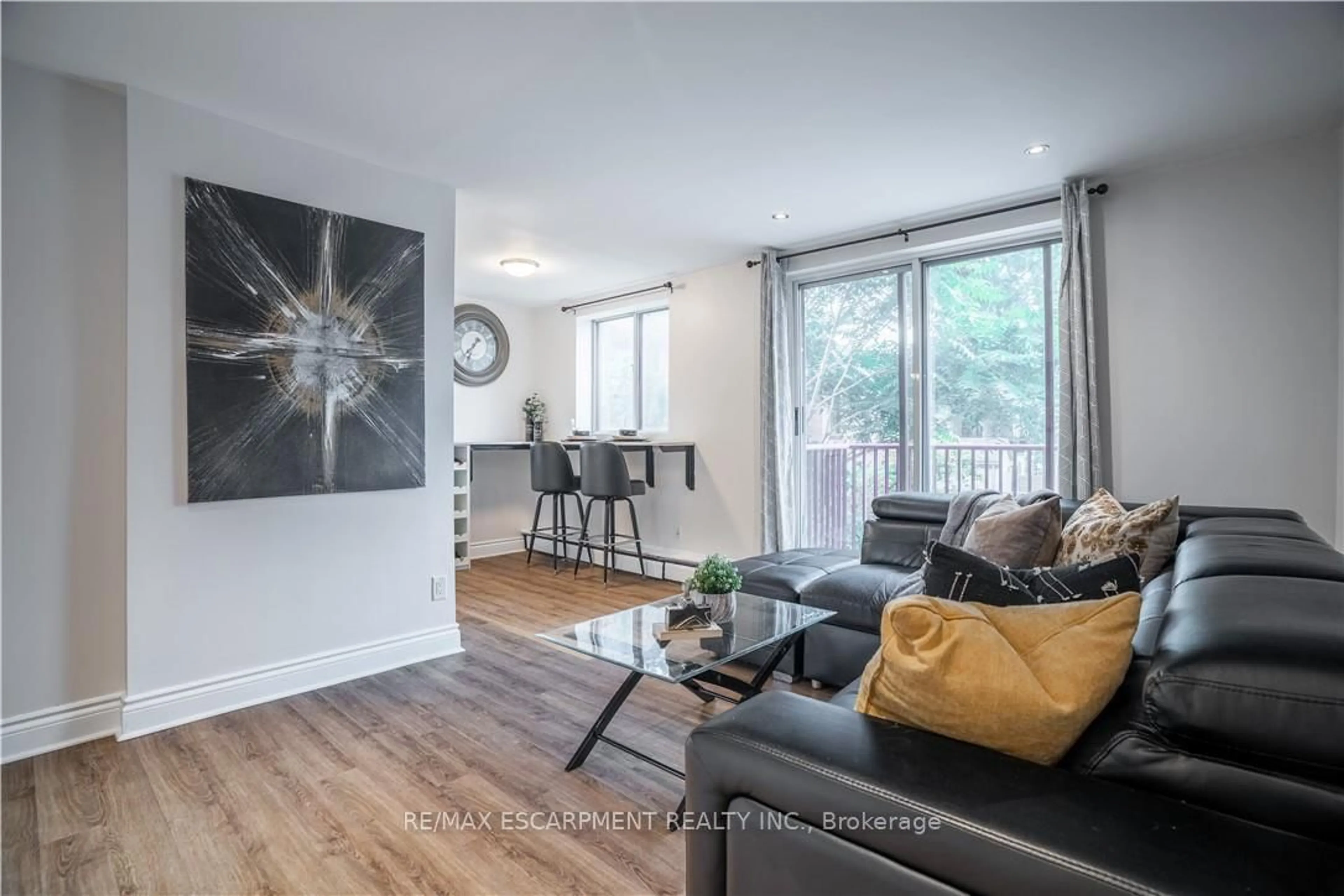 Living room with furniture, wood/laminate floor for 141 Catharine St #204, Hamilton Ontario L8N 2J7