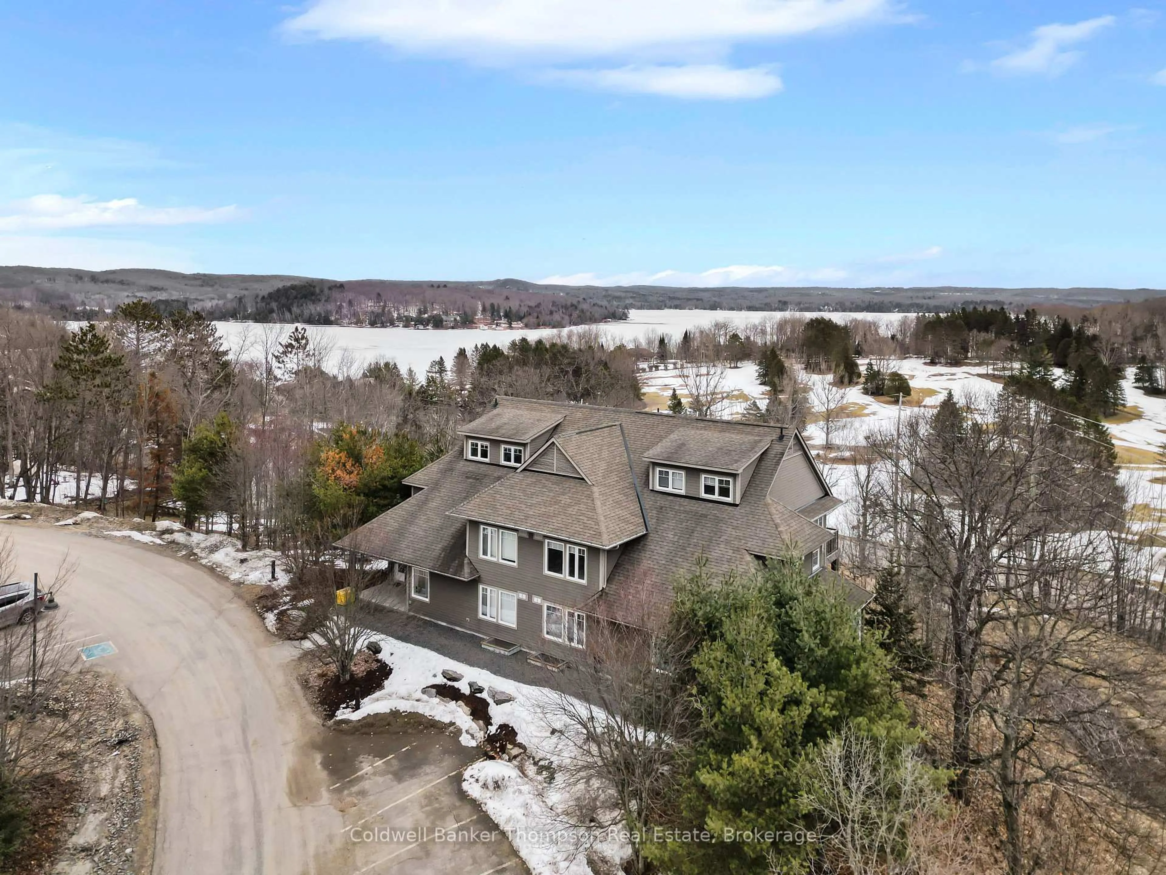 A pic from outside/outdoor area/front of a property/back of a property/a pic from drone, water/lake/river/ocean view for 1 TREE TOPS Lane #302, Huntsville Ontario P1H 1A9