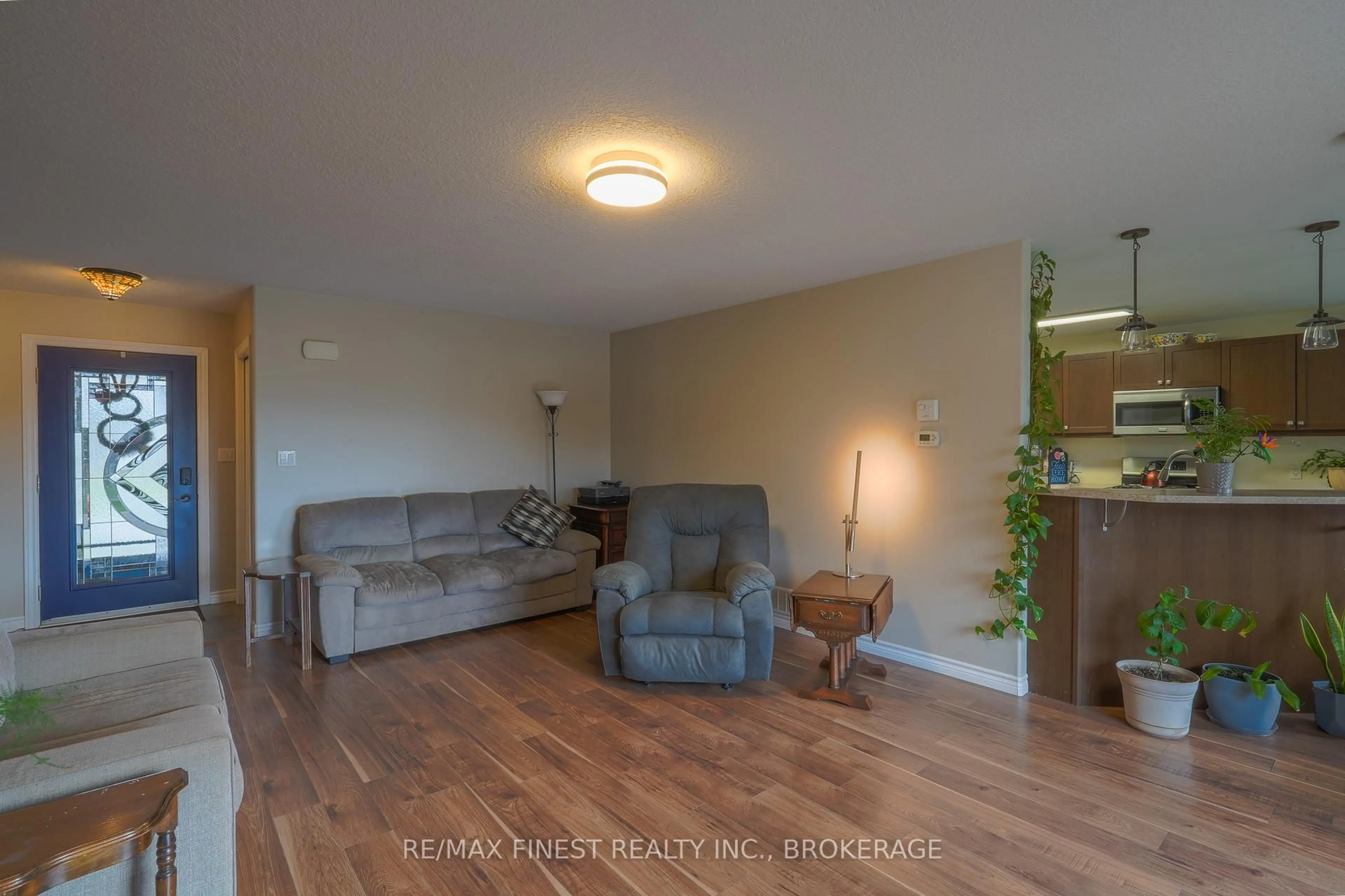 Living room with furniture, wood/laminate floor for 23 Creighton Dr, Bissett Creek Ontario K0H 2H0