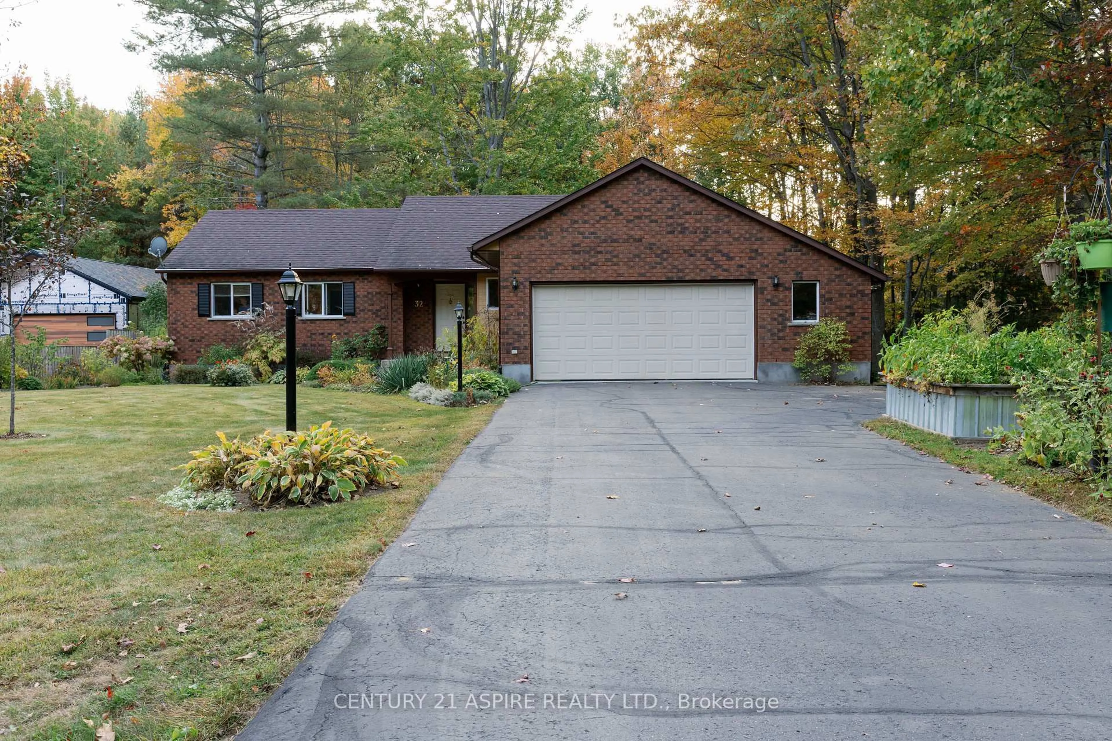 Home with brick exterior material, street for 32 Country Lane, Petawawa Ontario K8H 3J9