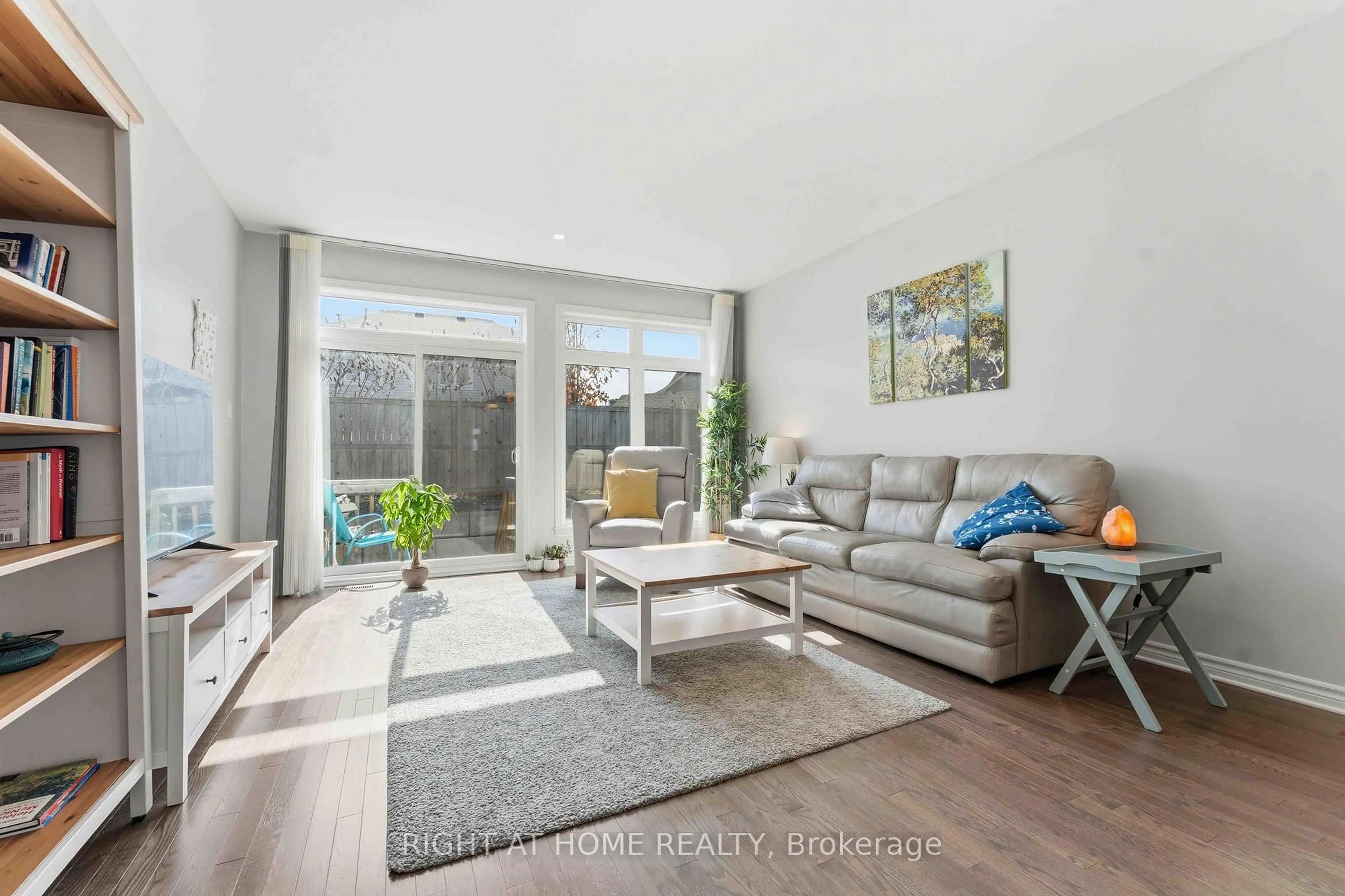 Living room with furniture, wood/laminate floor for 272 Maygrass Way, Ottawa Ontario K2S 2K9