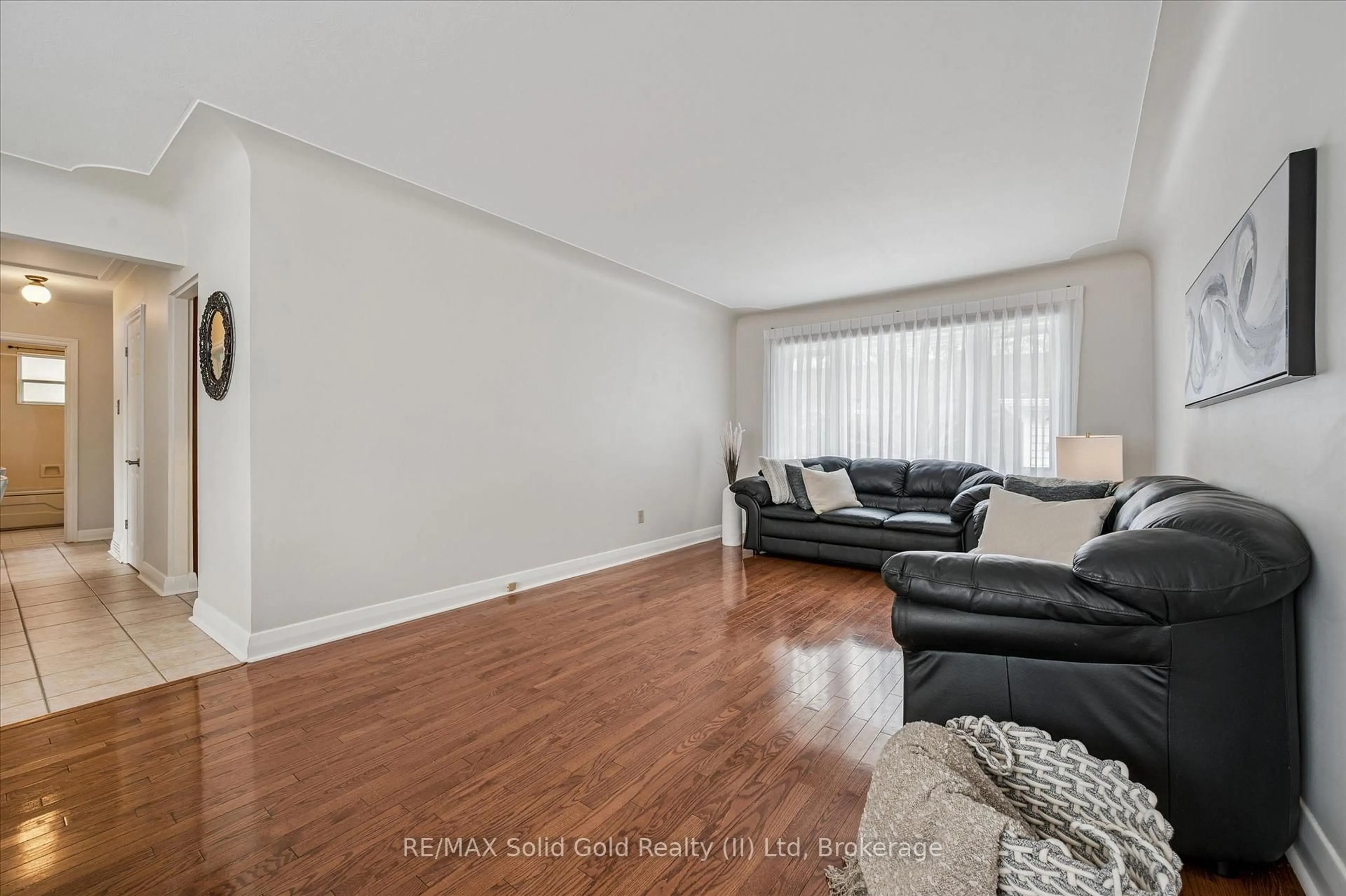 Living room with furniture, wood/laminate floor for 390 Dumfries Ave, Waterloo Ontario N2H 2G1
