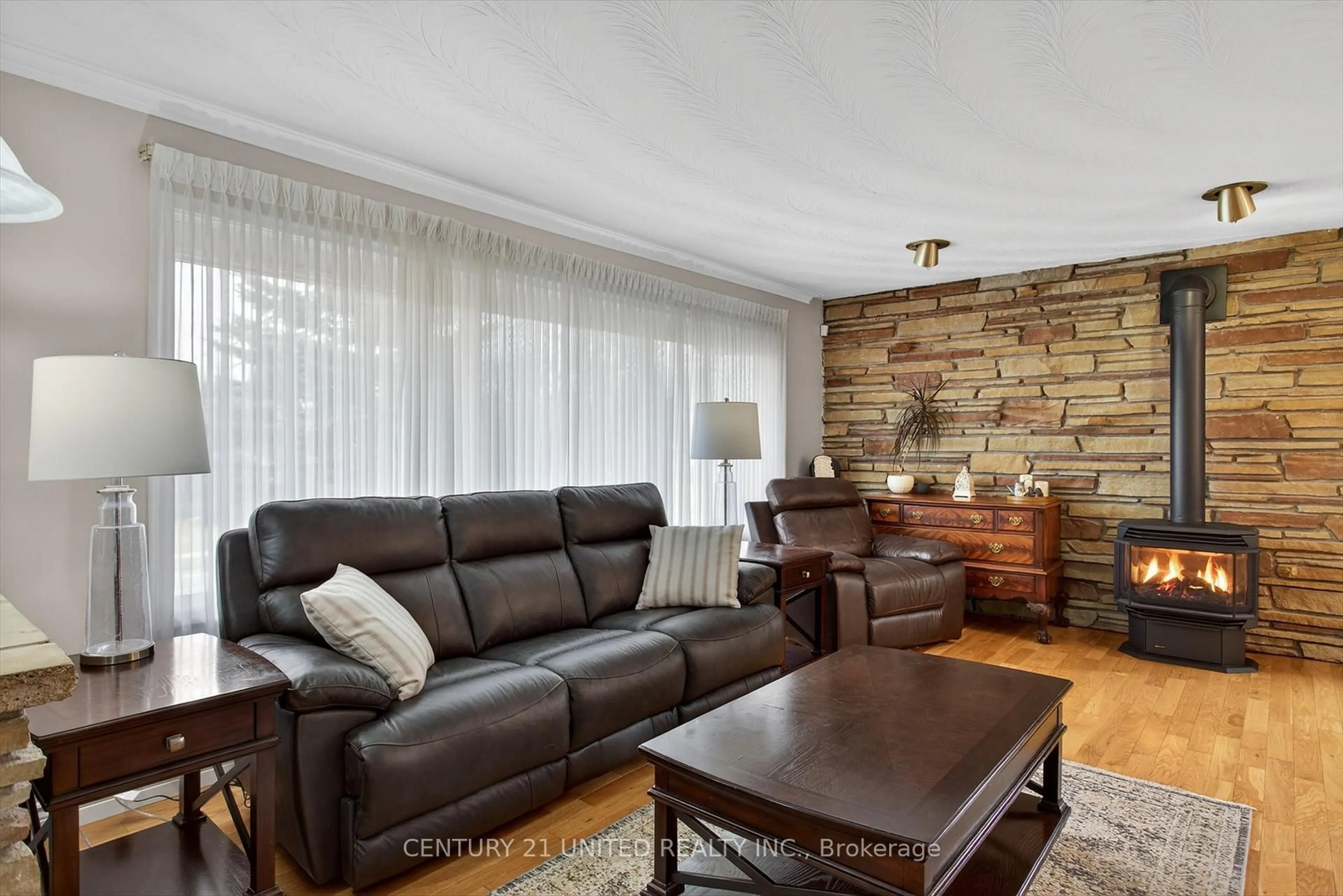 Living room with furniture, wood/laminate floor for 59 Kawartha Hts Blvd, Peterborough Ontario K9J 1N5