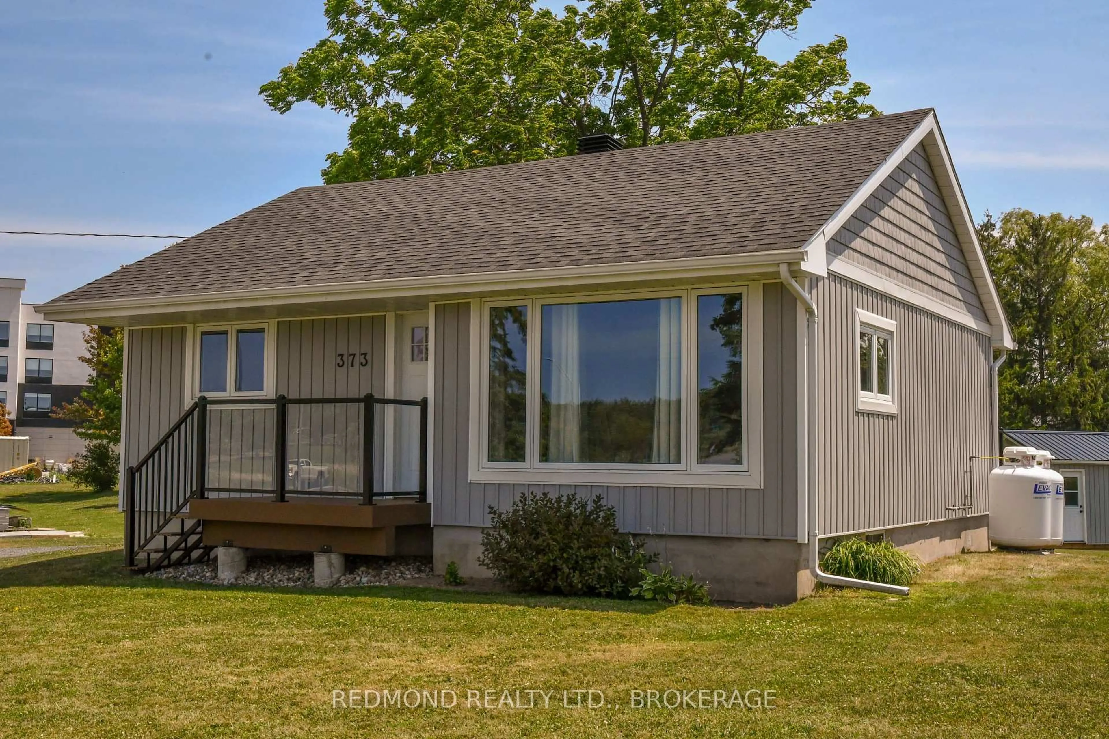 Home with vinyl exterior material, street for 373 Highway 2 Rd, Front of Leeds & Seeleys Bay Ontario K7G 2V4