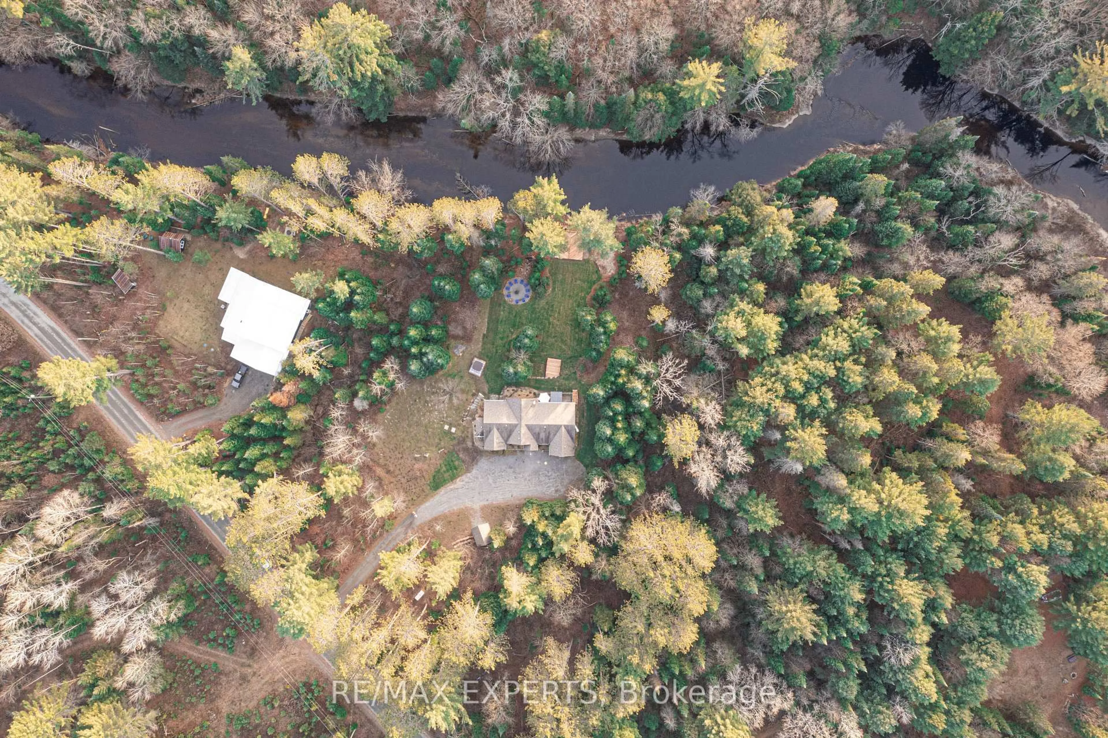 A pic from outside/outdoor area/front of a property/back of a property/a pic from drone, forest/trees view for 1216 Miriam Dr, Bracebridge Ontario P1L 1X1
