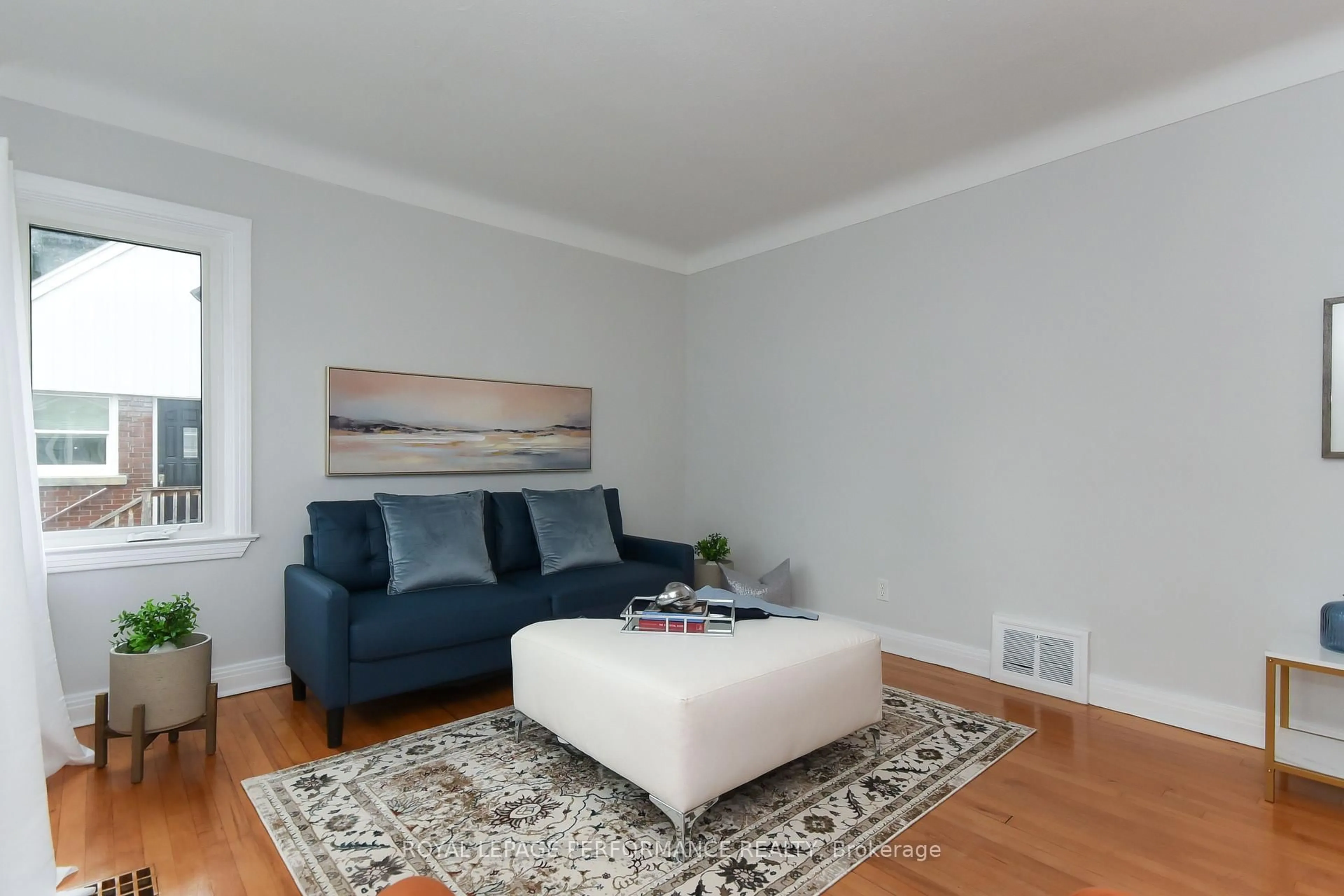 Living room with furniture, wood/laminate floor for 274 Queen Mary St, Ottawa Ontario K1K 1X2