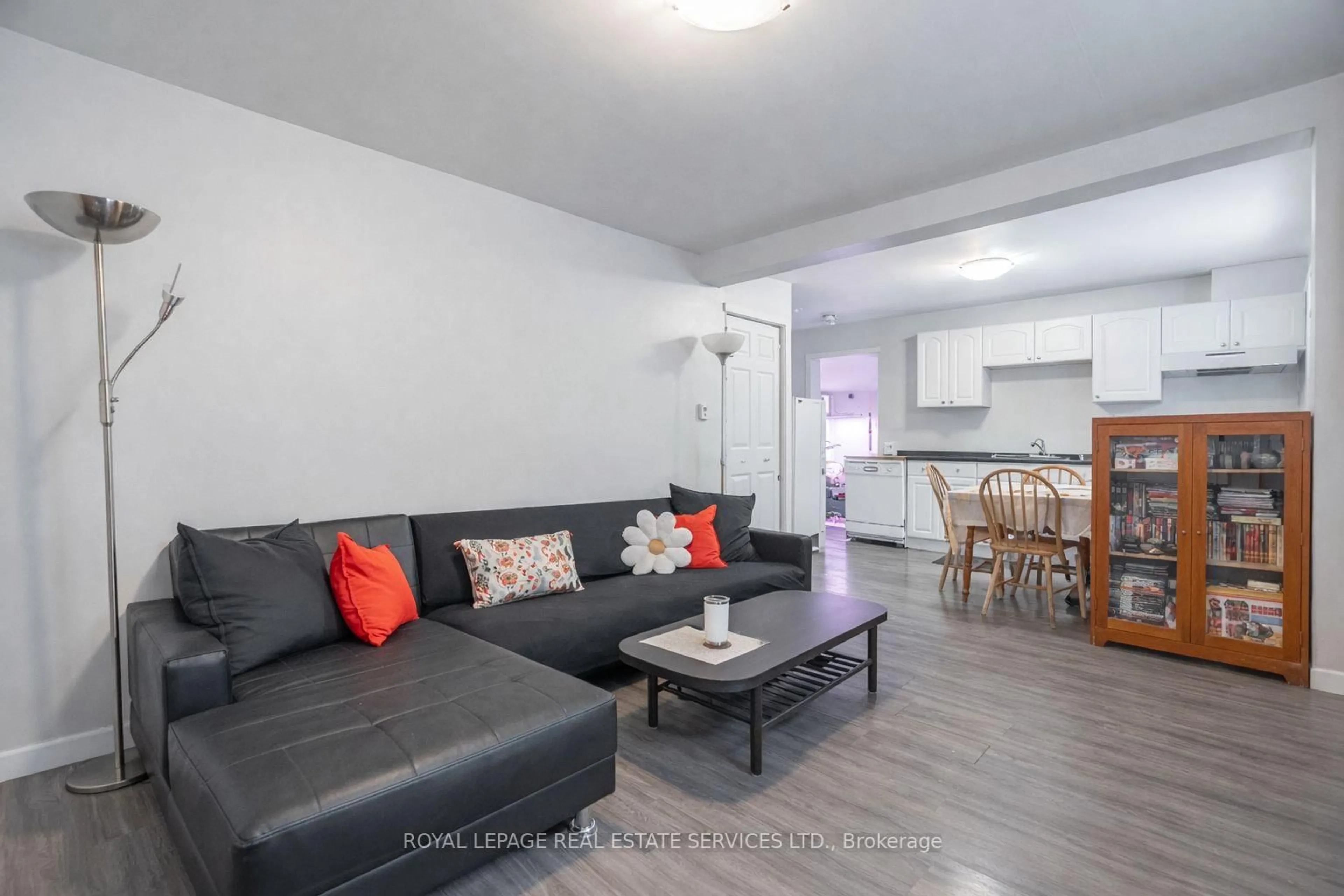 Living room with furniture, wood/laminate floor for 108 Queenston St, St. Catharines Ontario L2R 2Z3