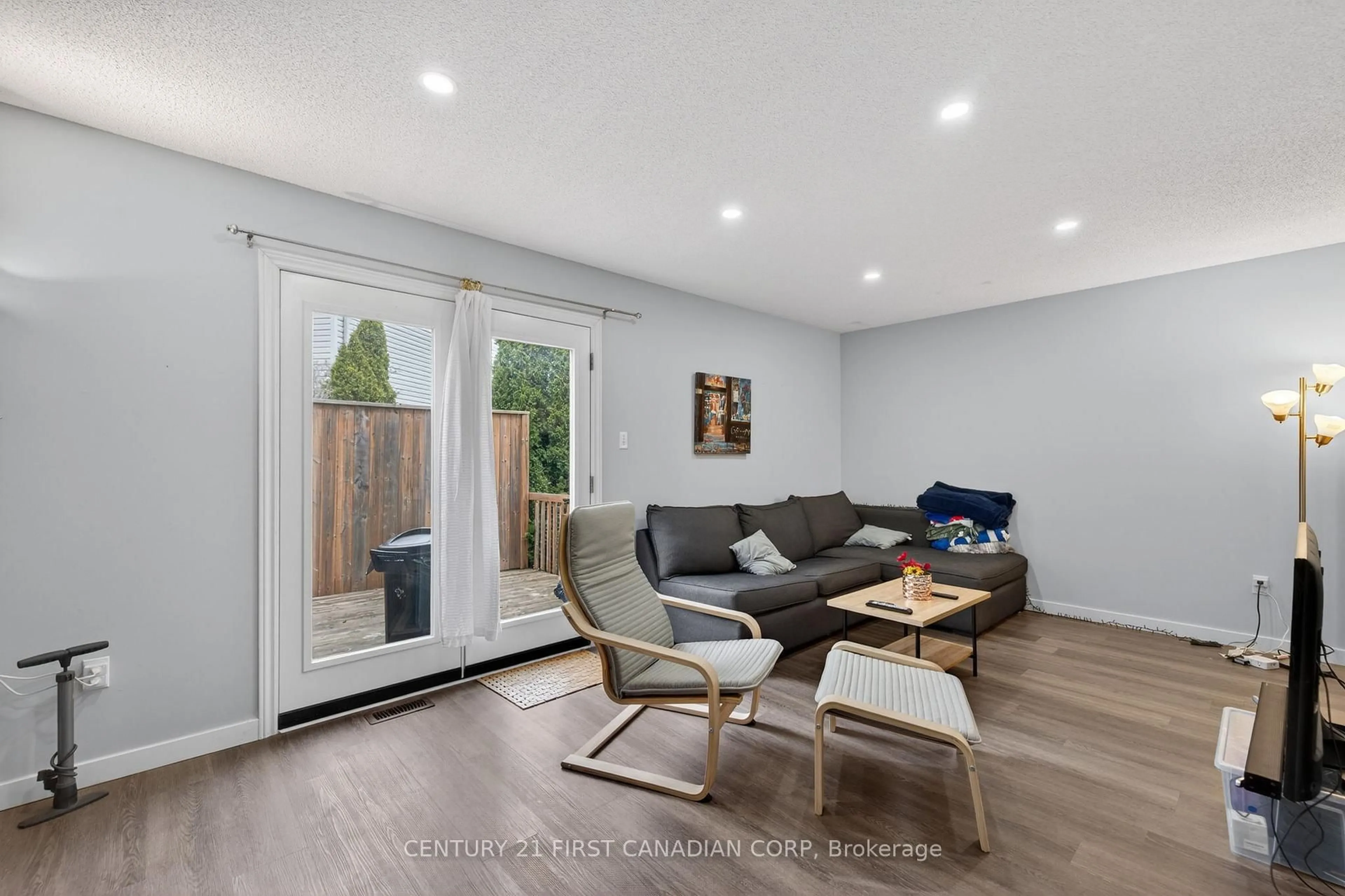 Living room with furniture, wood/laminate floor for 70 Chapman Crt #55, London North Ontario N6G 4Z4