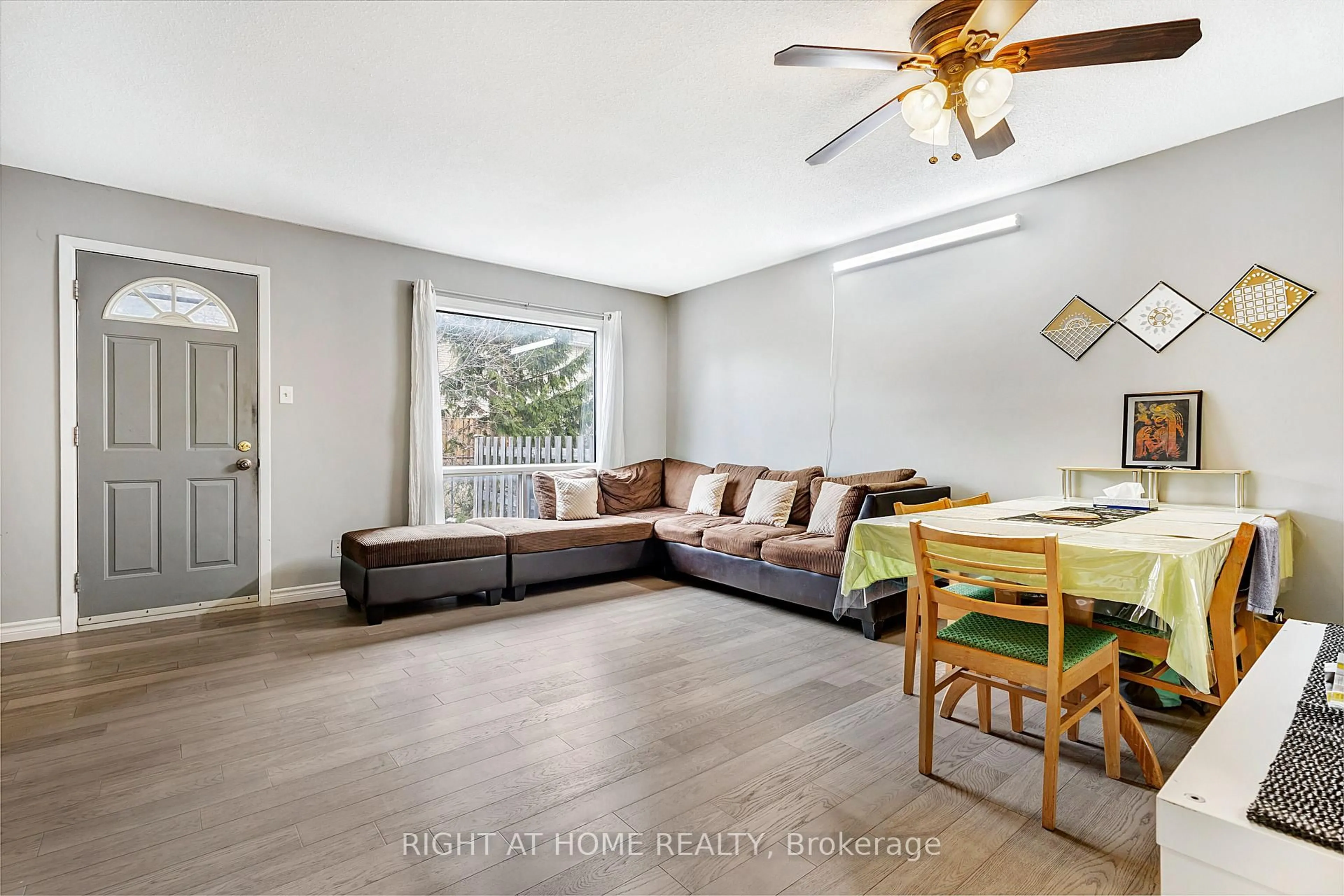 Living room with furniture, wood/laminate floor for 1324 Belgate Way, Ottawa Ontario K1J 8P9