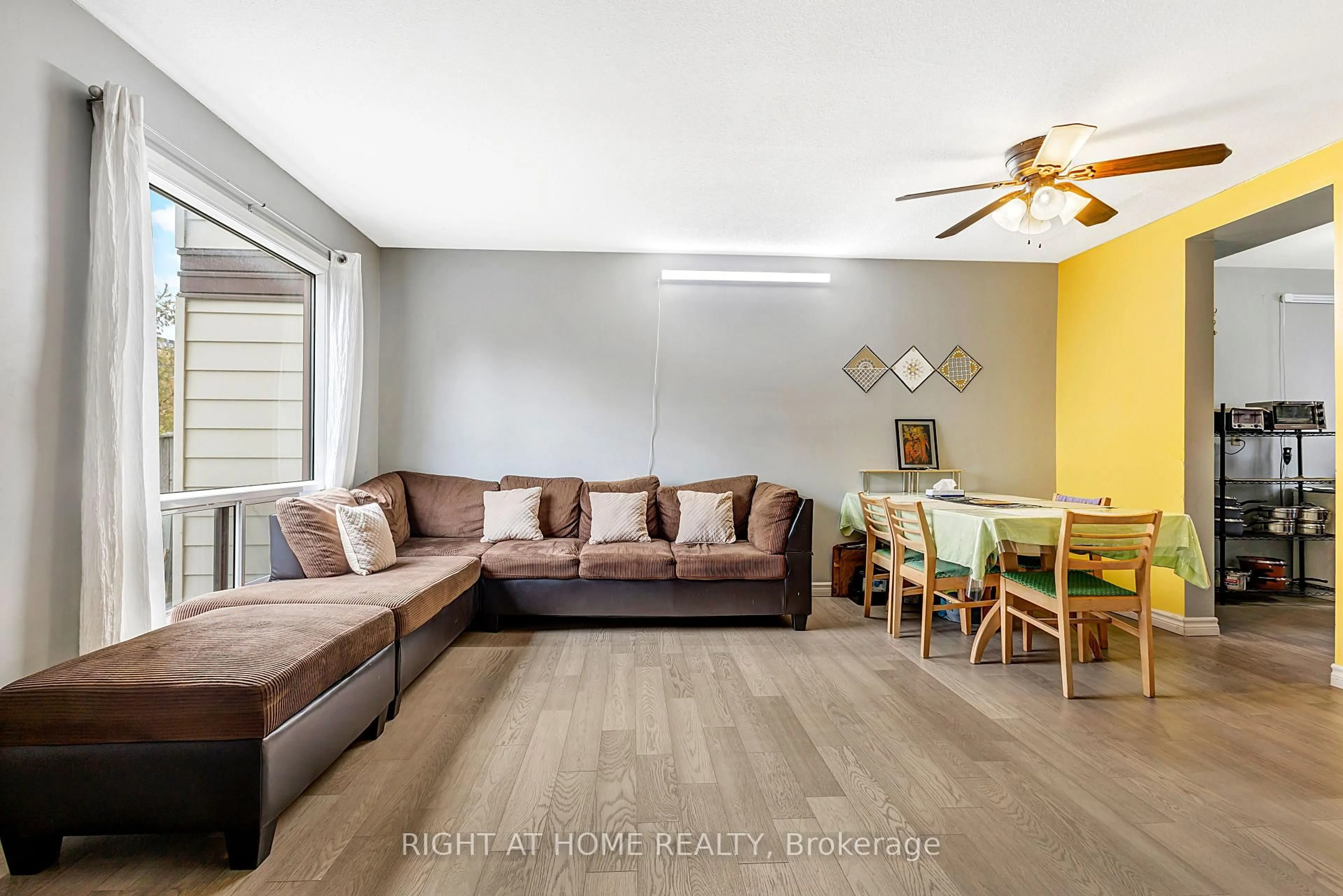 Living room with furniture, wood/laminate floor for 1324 Belgate Way, Ottawa Ontario K1J 8P9