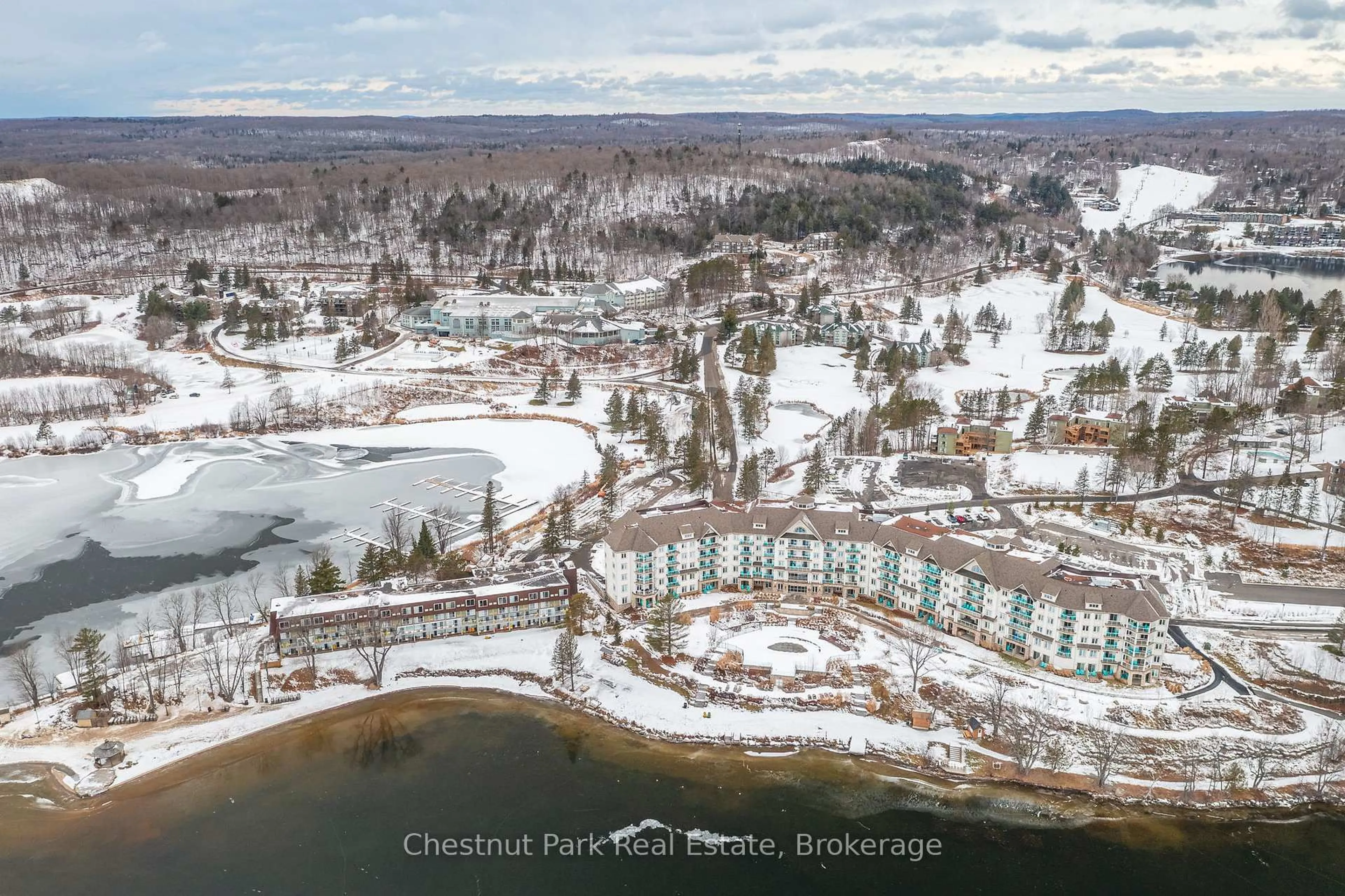 A pic from outside/outdoor area/front of a property/back of a property/a pic from drone, water/lake/river/ocean view for 25 Pen Lake Point Rd #206, Huntsville Ontario P1H 1A9
