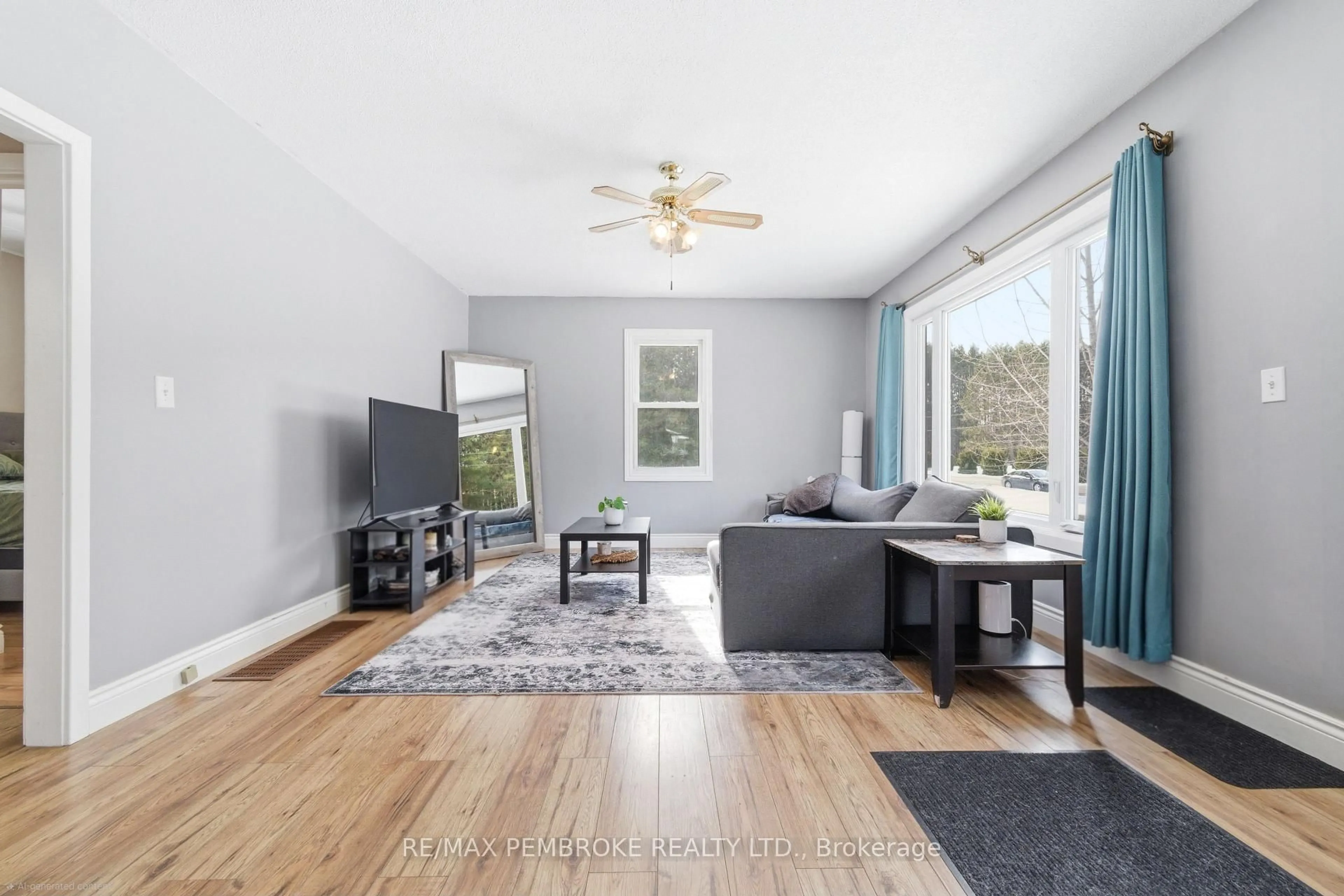 Living room with furniture, wood/laminate floor for 613 Airport Rd, Petawawa Ontario K8A 6W7