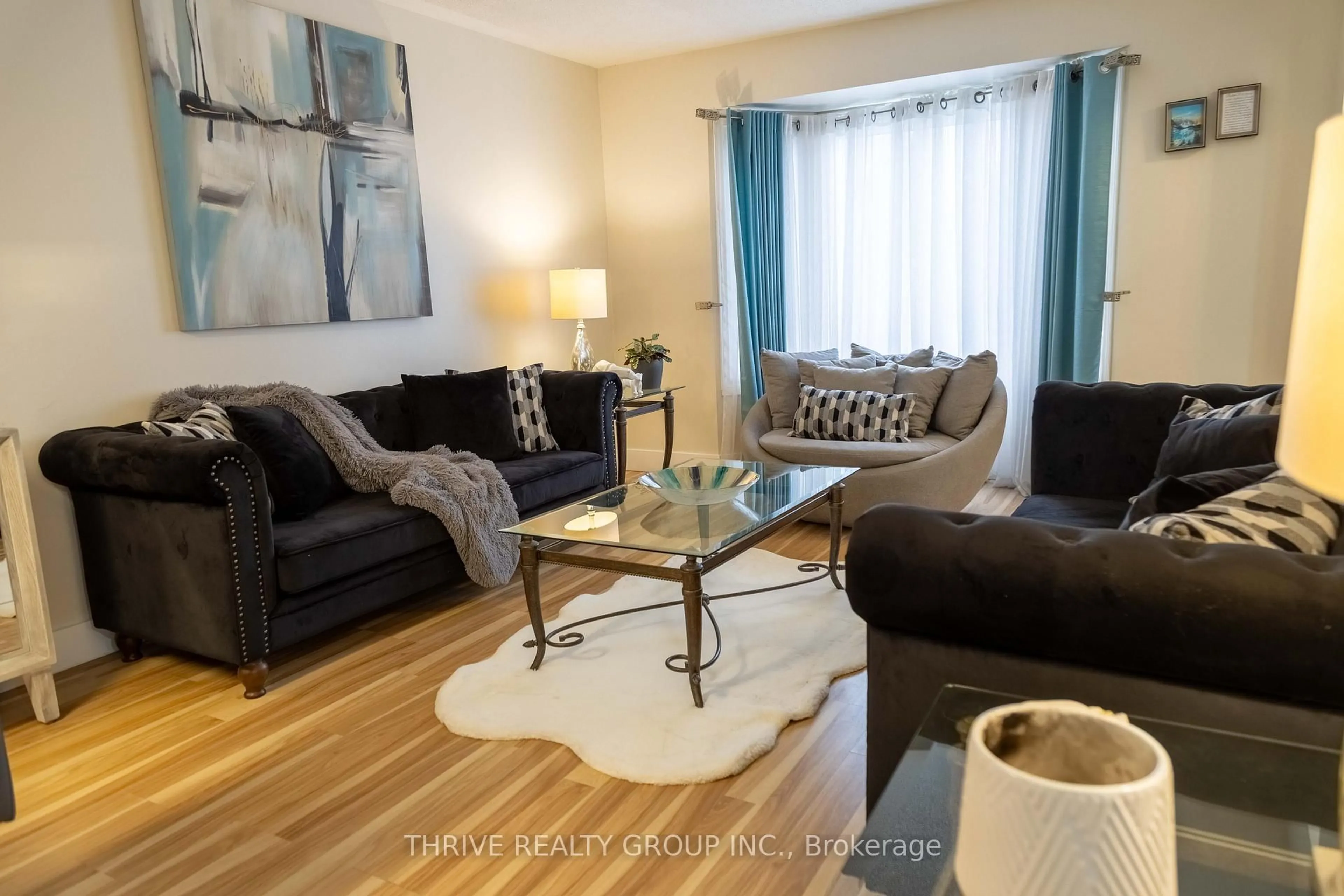 Living room with furniture, wood/laminate floor for 180 Clara Cres, London South Ontario N6E 3H2