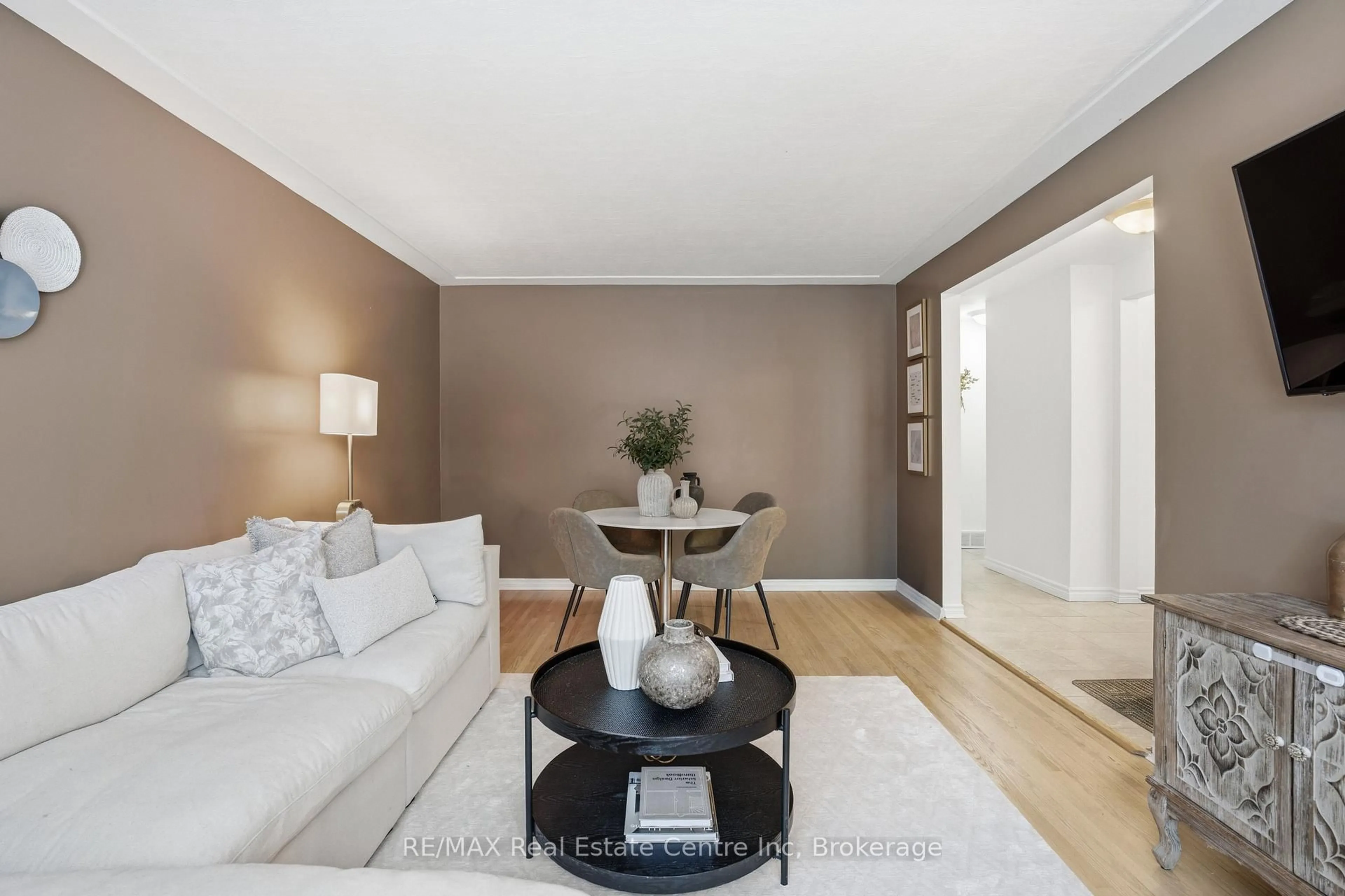 Living room with furniture, wood/laminate floor for 154 Waverley Dr, Guelph Ontario N1E 1H2