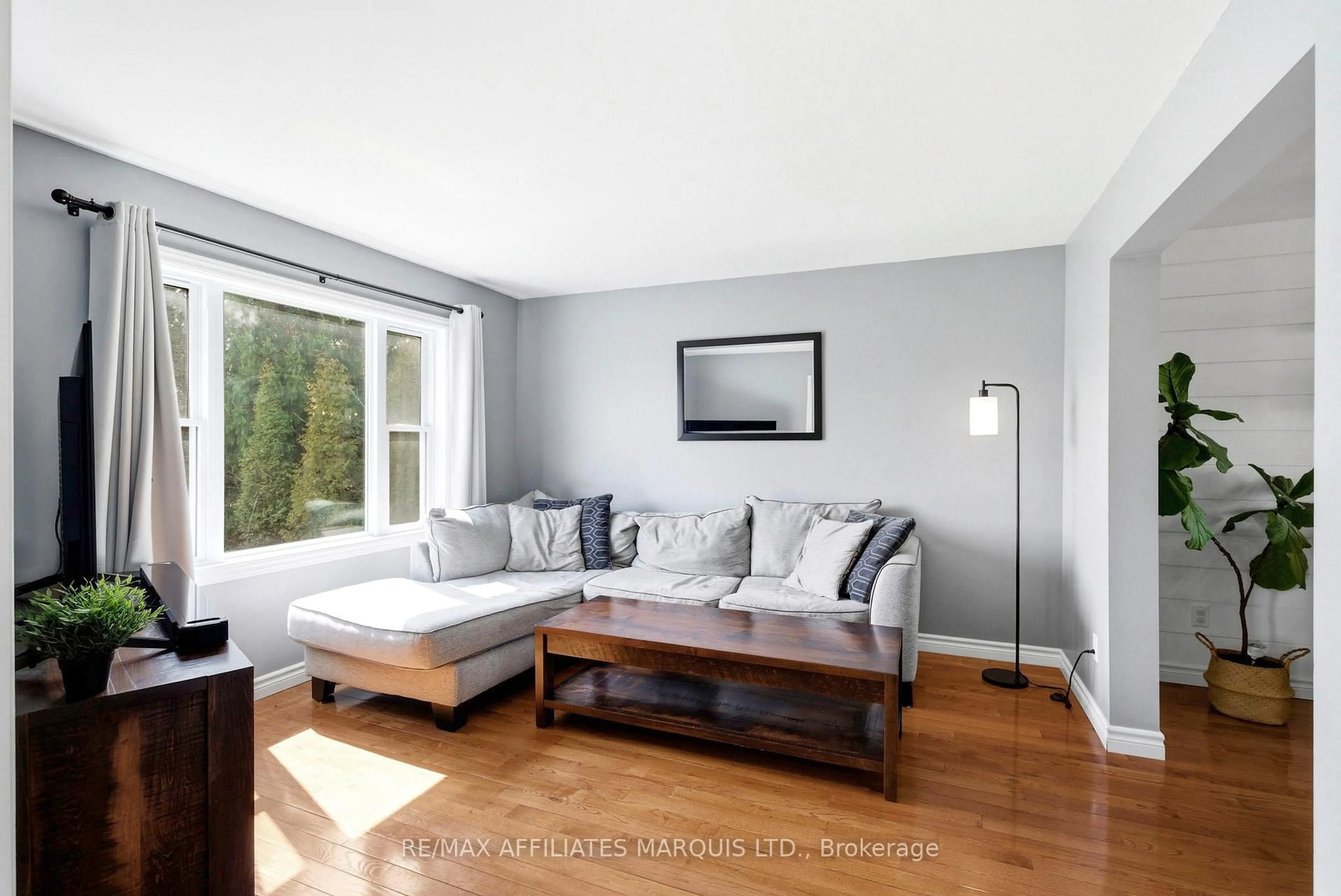 Living room with furniture, wood/laminate floor for 14229 County Road 2 Rd, South Stormont Ontario K0C 1M0