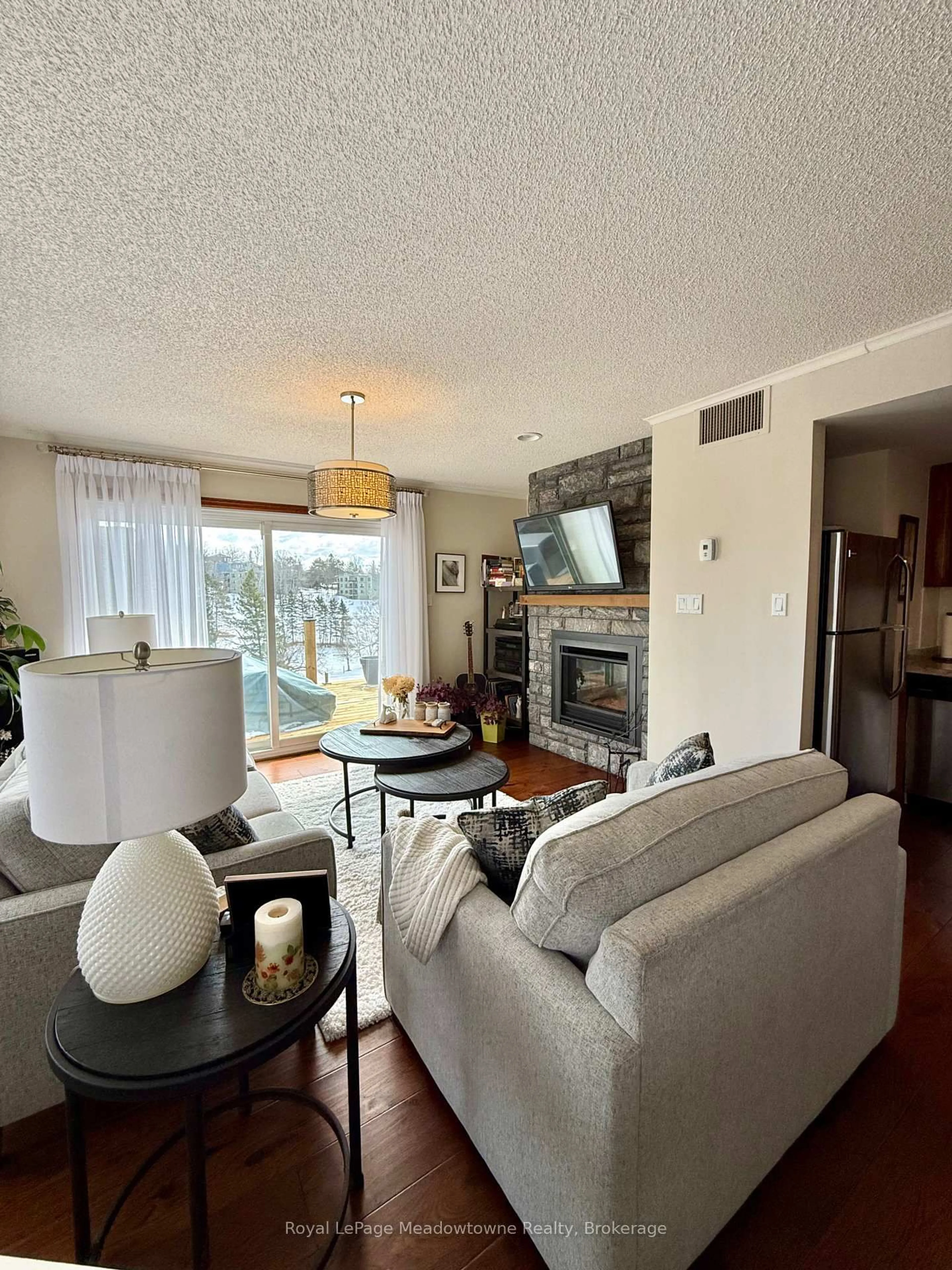 Living room with furniture, wood/laminate floor for 34 Deerhurst Greens Rd #301, Huntsville Ontario P1H 1A9