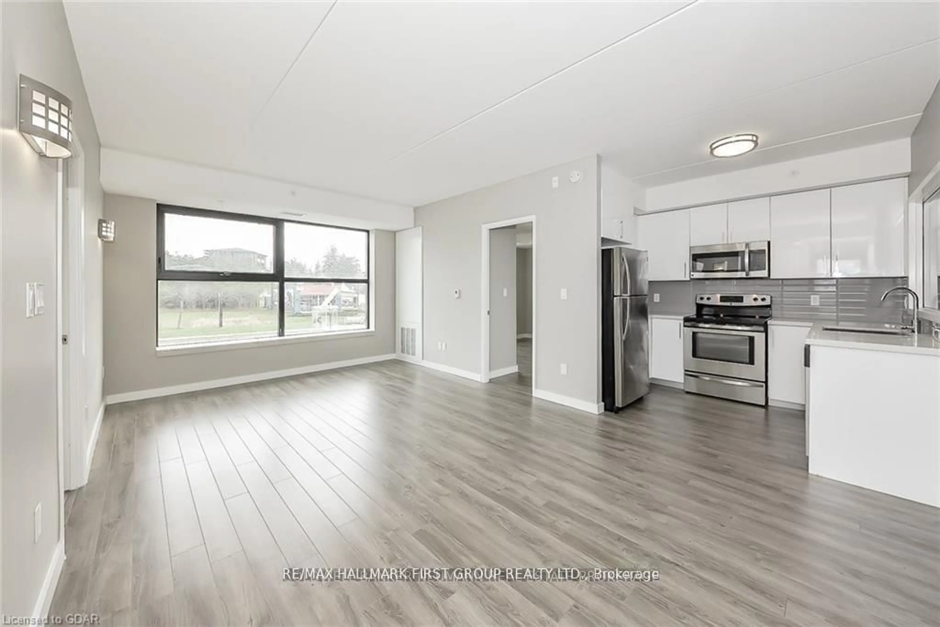 Open concept kitchen, wood/laminate floor for 1291 Gordon St #124, Guelph Ontario N1L 0M5