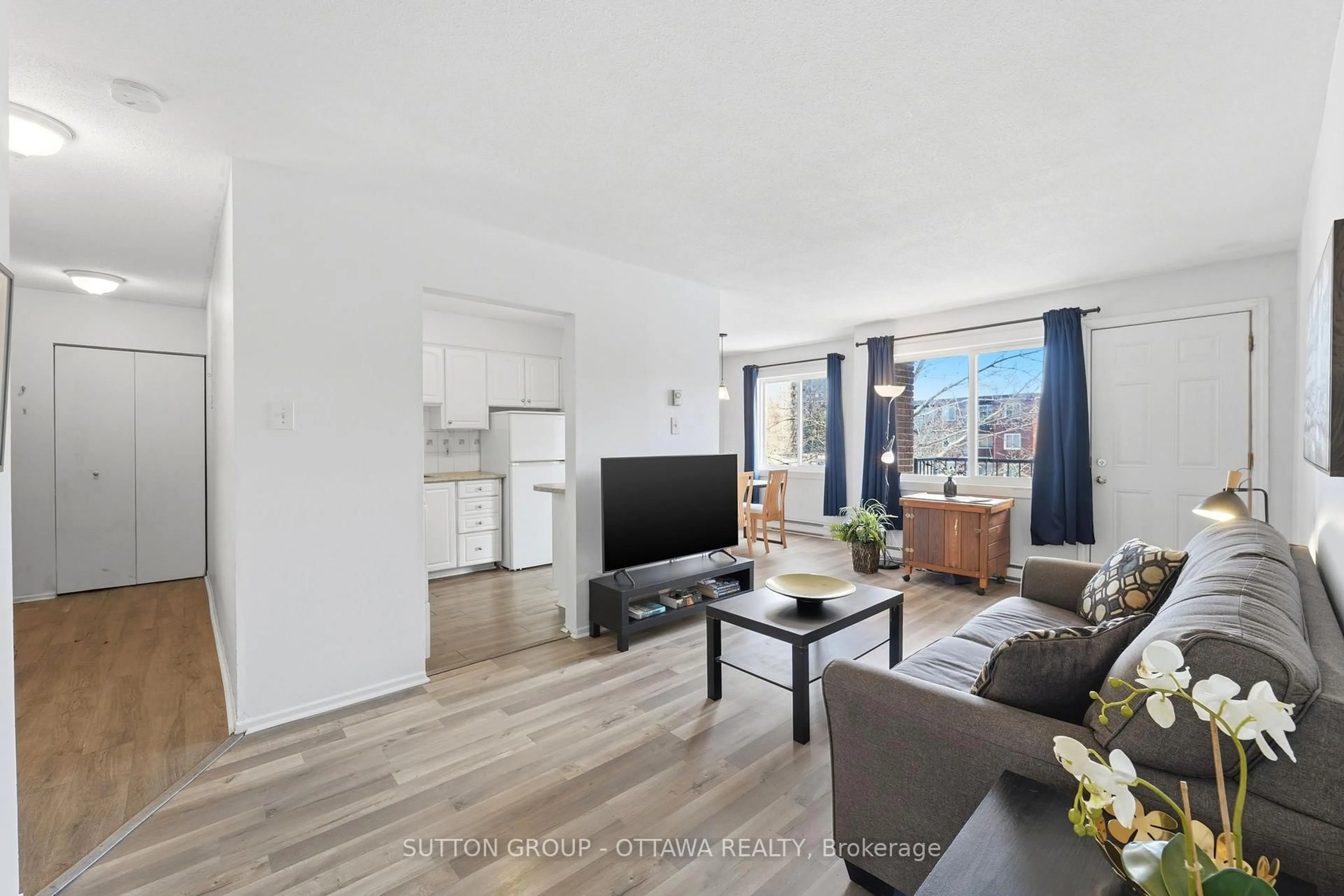 Living room with furniture, wood/laminate floor for 2041 Arrowsmith Dr #308B, Ottawa Ontario K1J 7V7