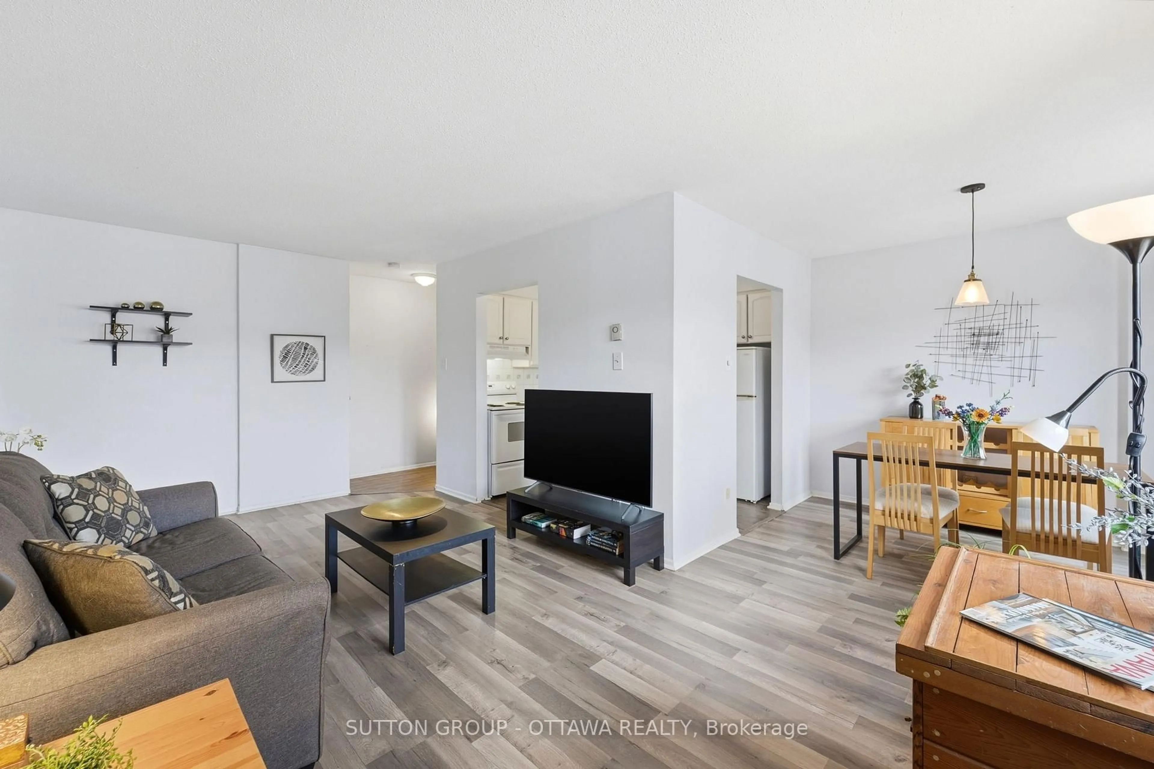 Living room with furniture, wood/laminate floor for 2041 Arrowsmith Dr #308B, Ottawa Ontario K1J 7V7