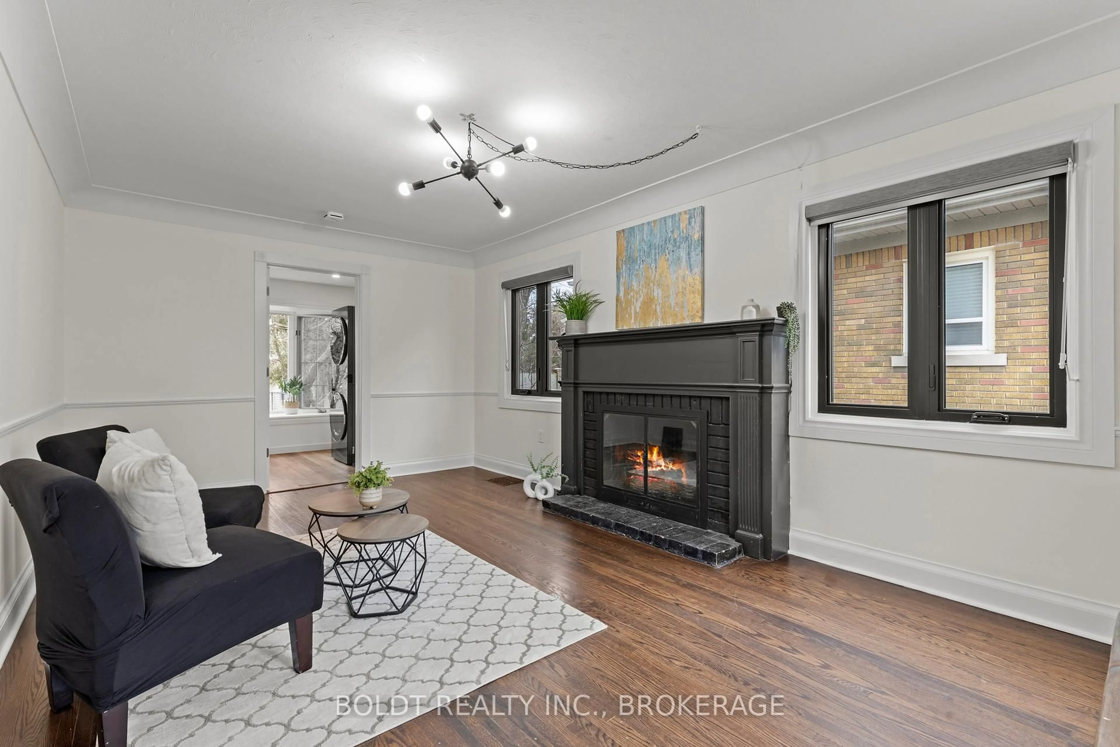 Living room with furniture, wood/laminate floor for 322 Queenston St, St. Catharines Ontario L2P 2X7
