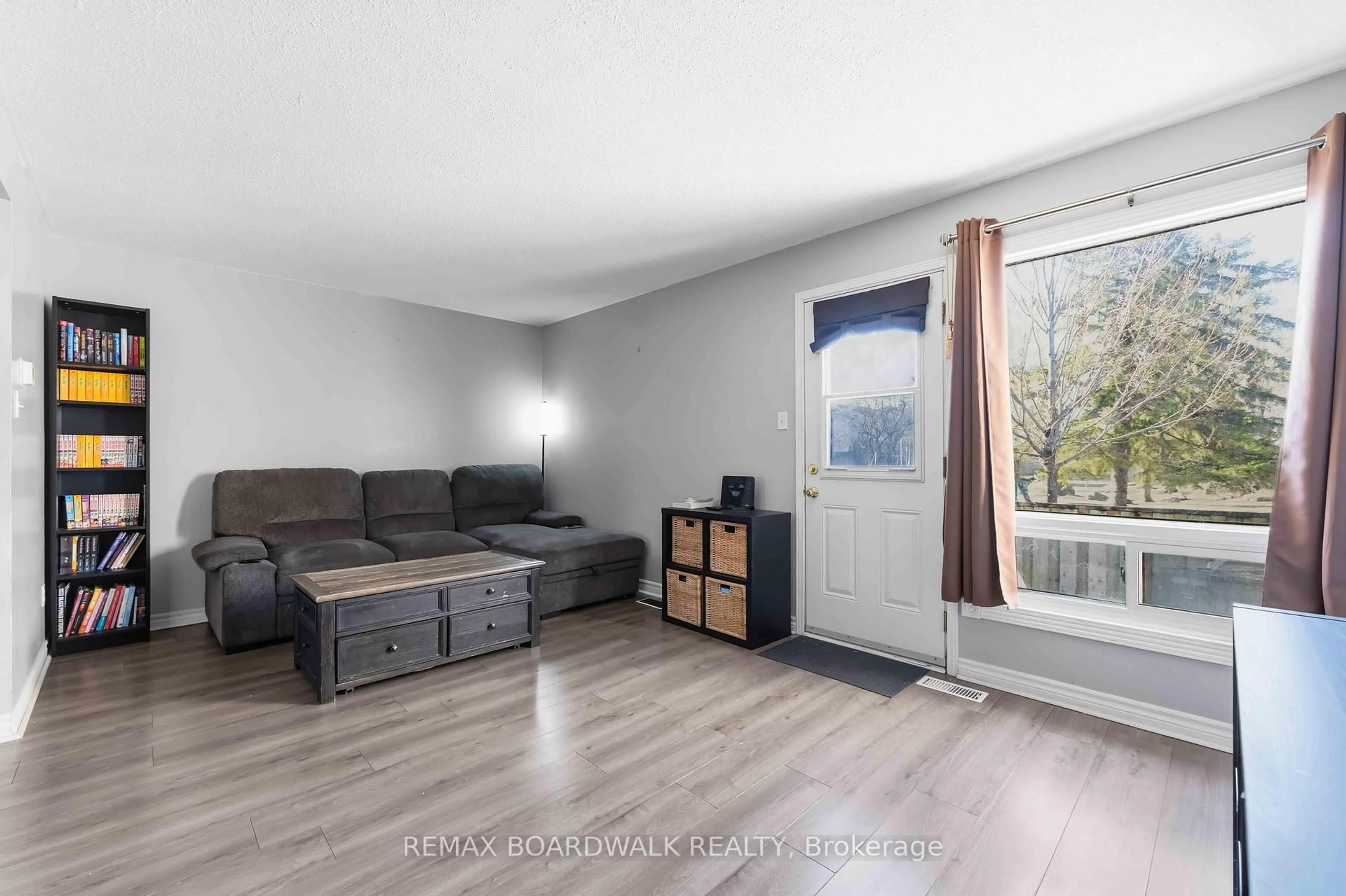 Living room with furniture, wood/laminate floor for 1707 Meadowbrook Rd, Ottawa Ontario K1B 4W6