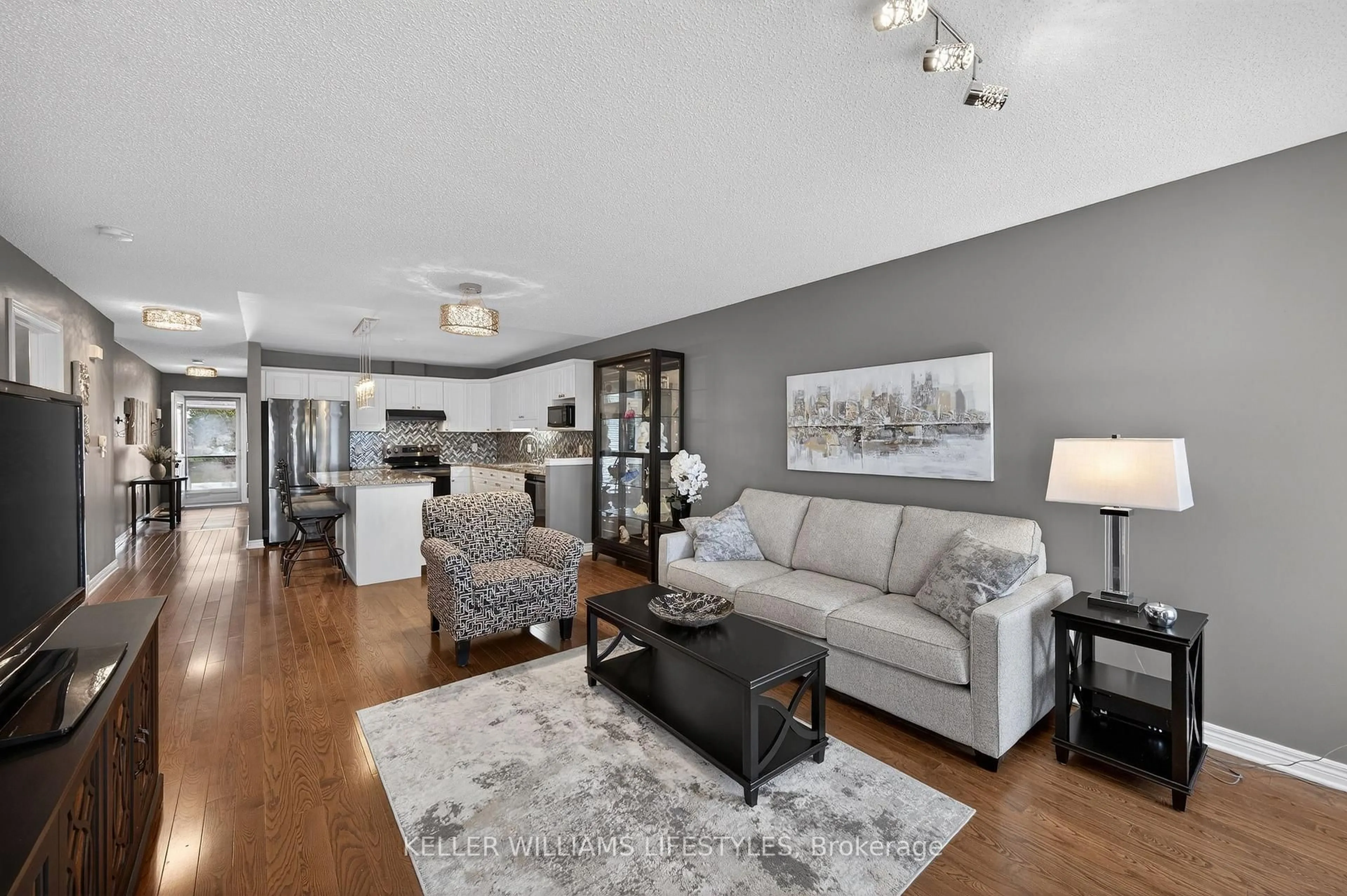 Living room with furniture, wood/laminate floor for 2025 Meadowgate Blvd #244, London South Ontario N6M 1K9