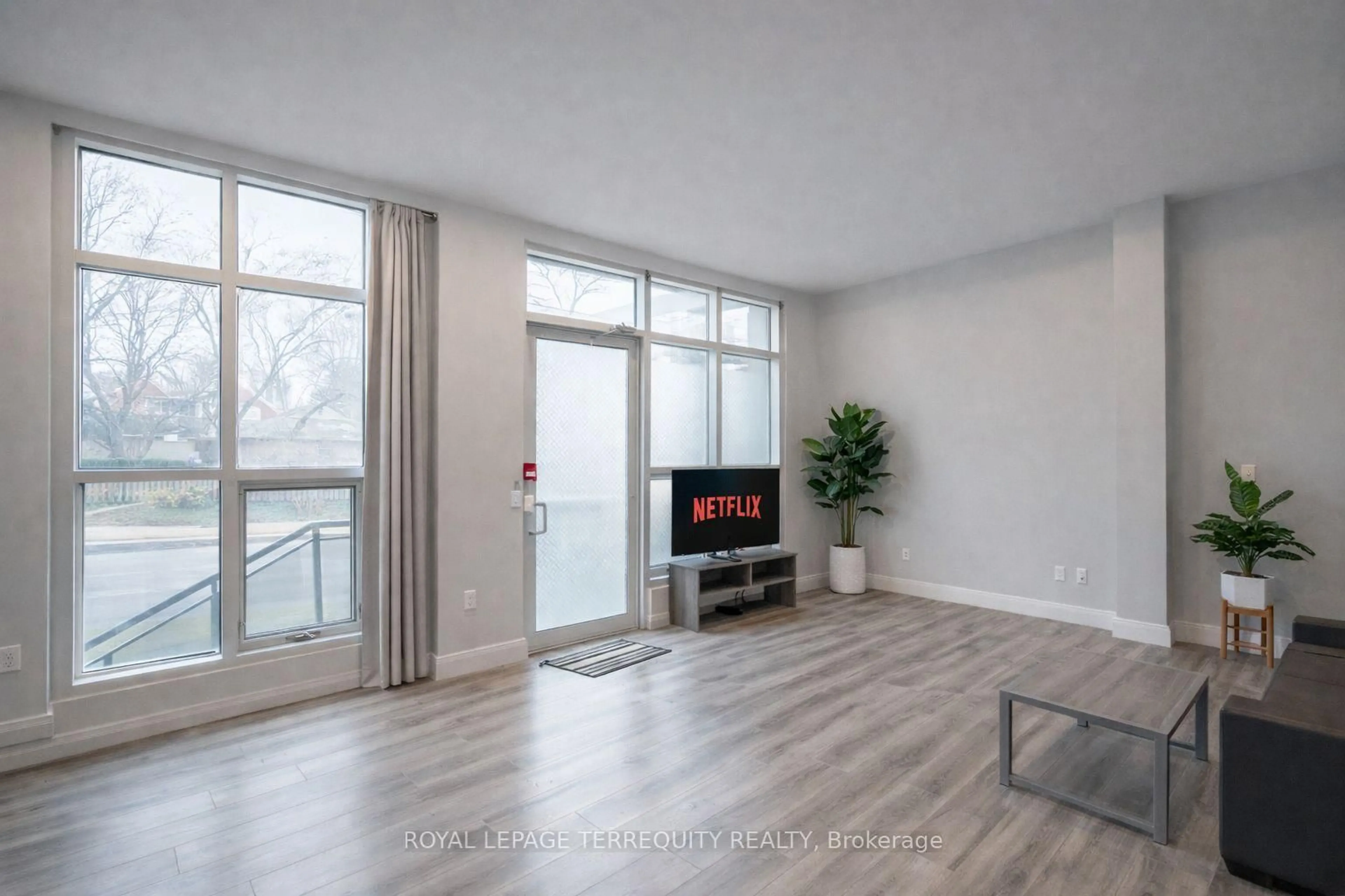Living room with furniture, wood/laminate floor for 275 Larch St #F106, Waterloo Ontario N2L 0J5