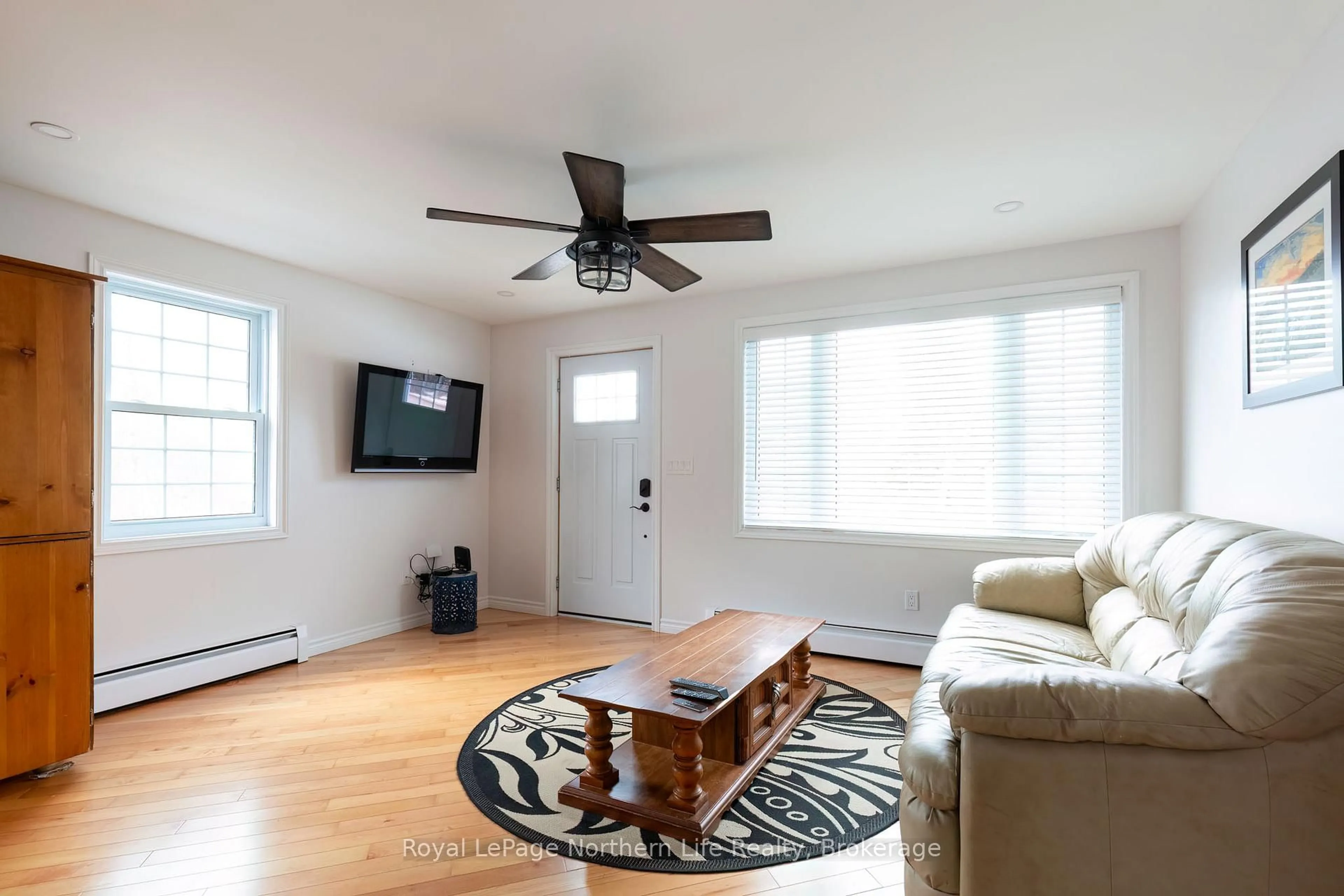 Living room with furniture, wood/laminate floor for 300 Yonge St, Bonfield Ontario P0H 1E0