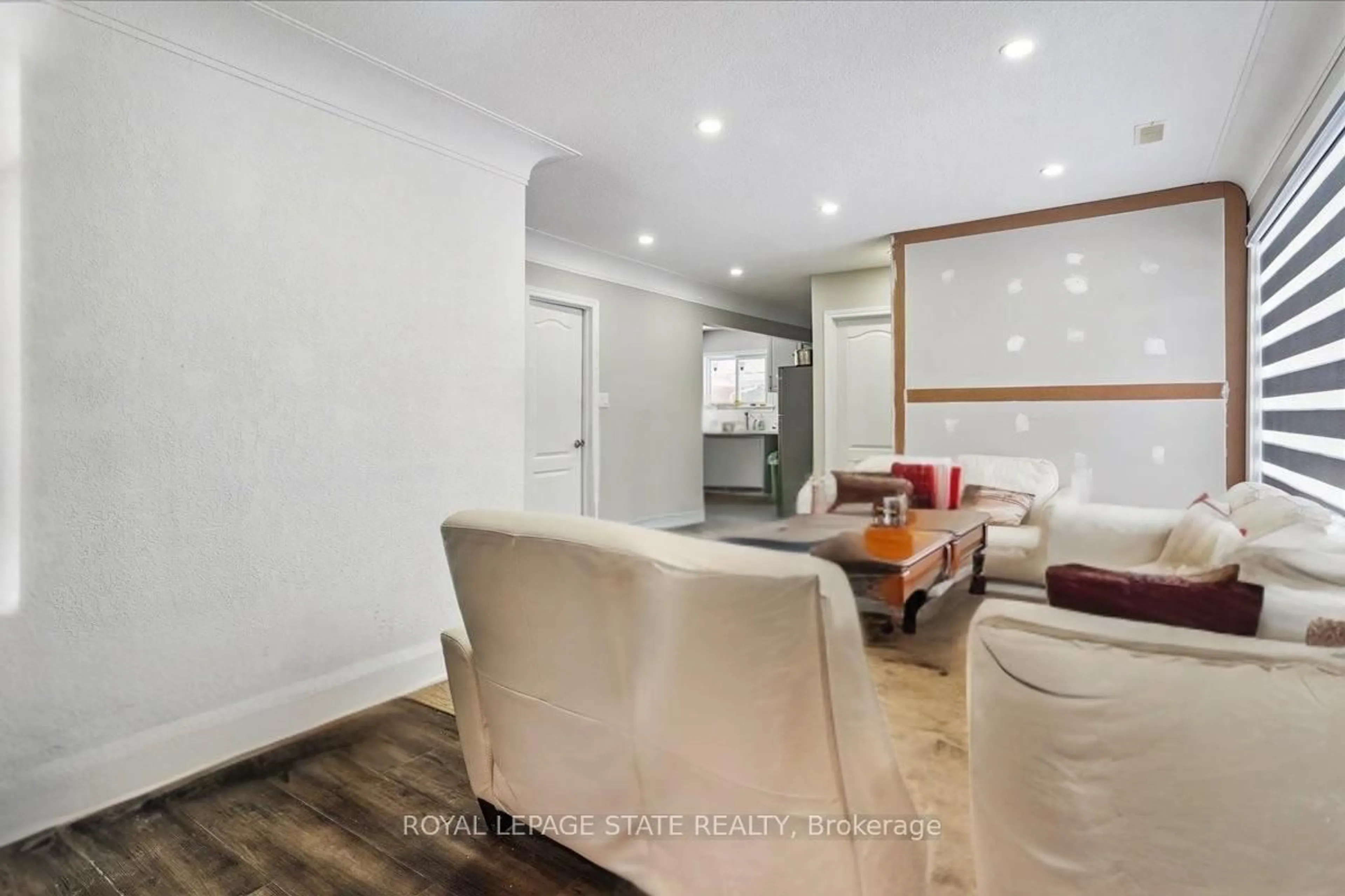 Living room with furniture, wood/laminate floor for 251 King St, Hamilton Ontario L8G 1L9