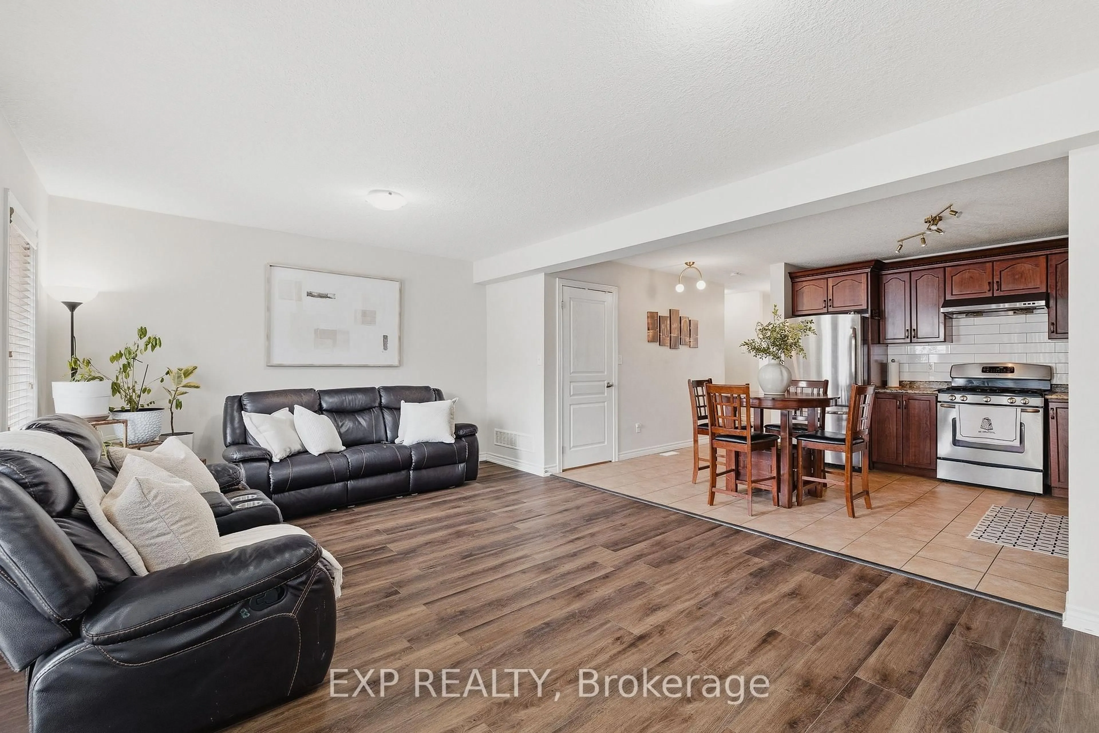 Living room with furniture, wood/laminate floor for 130 Simmonds Dr, Guelph Ontario N1E 7L8
