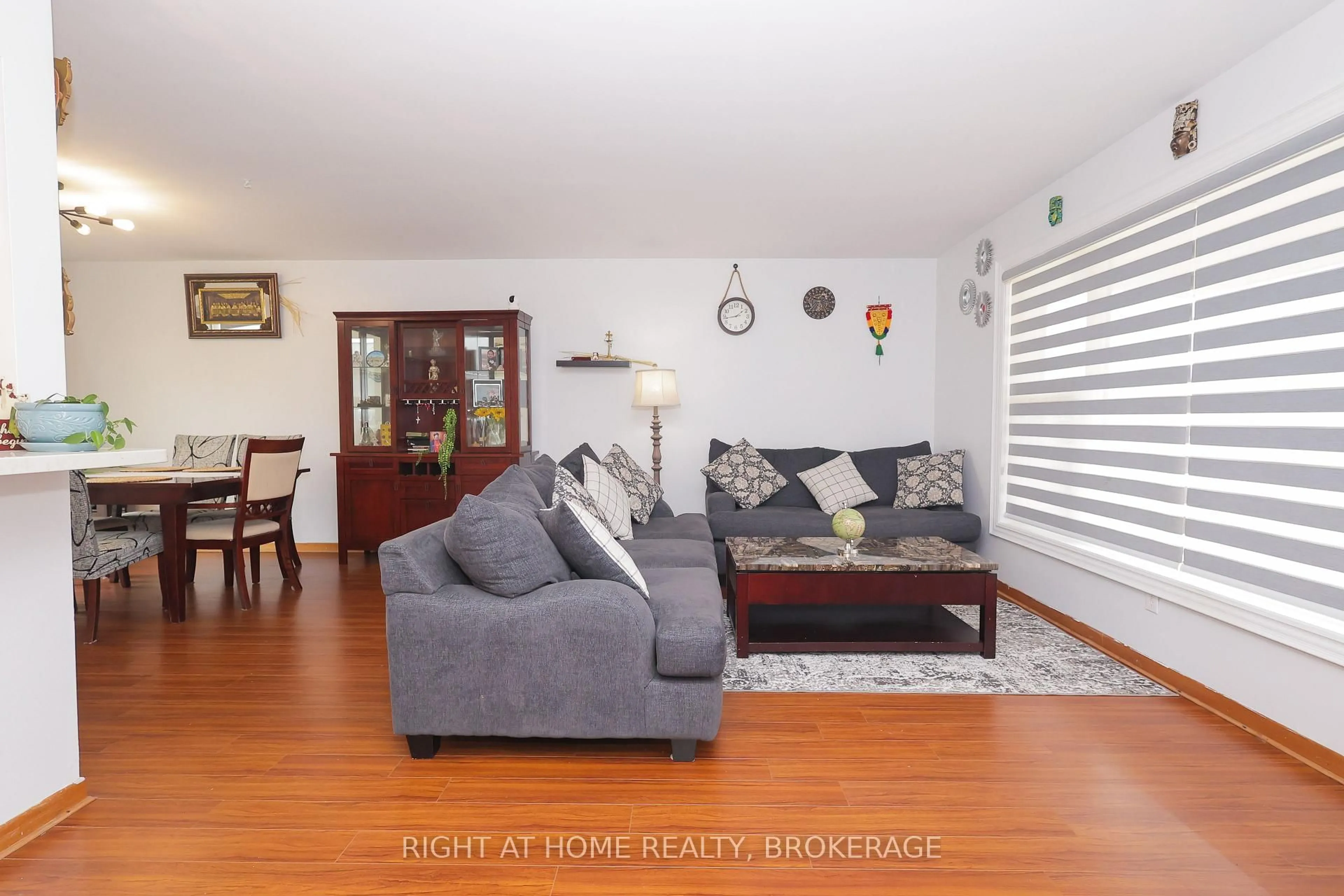 Living room with furniture, wood/laminate floor for 7698 Mulhern St, Niagara Falls Ontario L2H 1B5